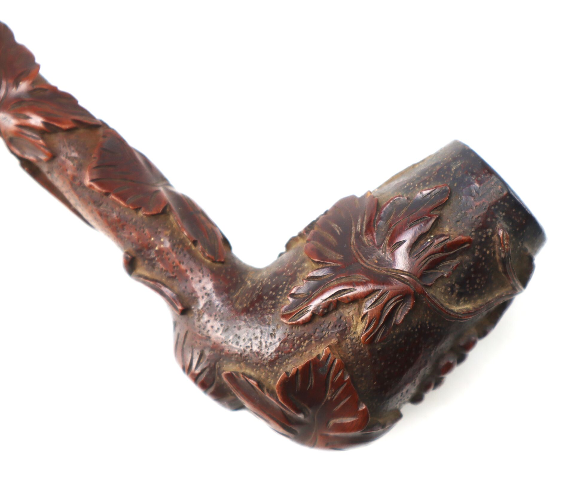 A Hand-Carved Civil War-Era Pipe featuring grape leaf motifs on the bowl and stem, photographed against a white background.