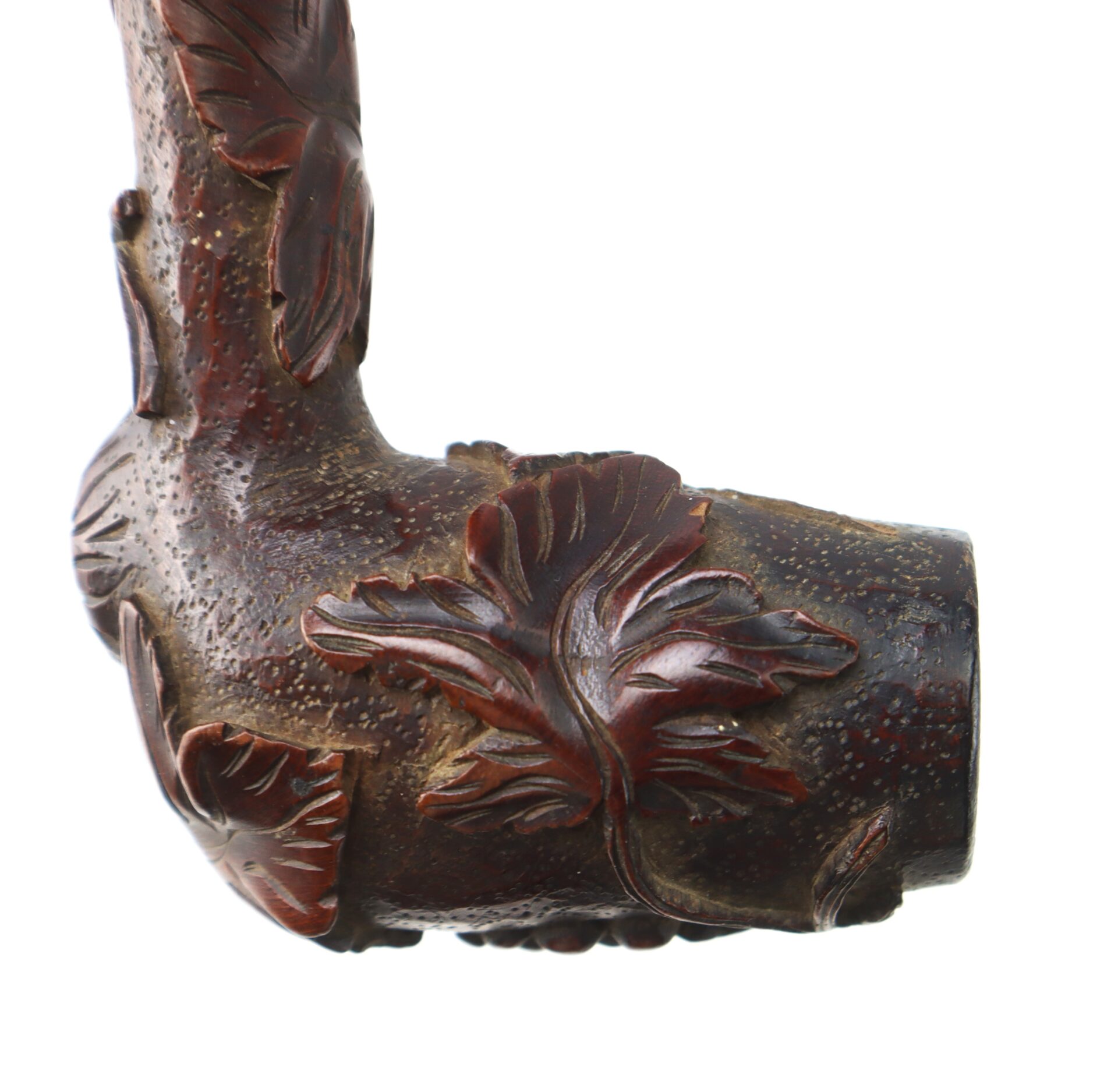Close-up of a Hand-Carved Civil War-Era Pipe bowl, highlighting its detailed grape leaf motif and textured surface against a white background.