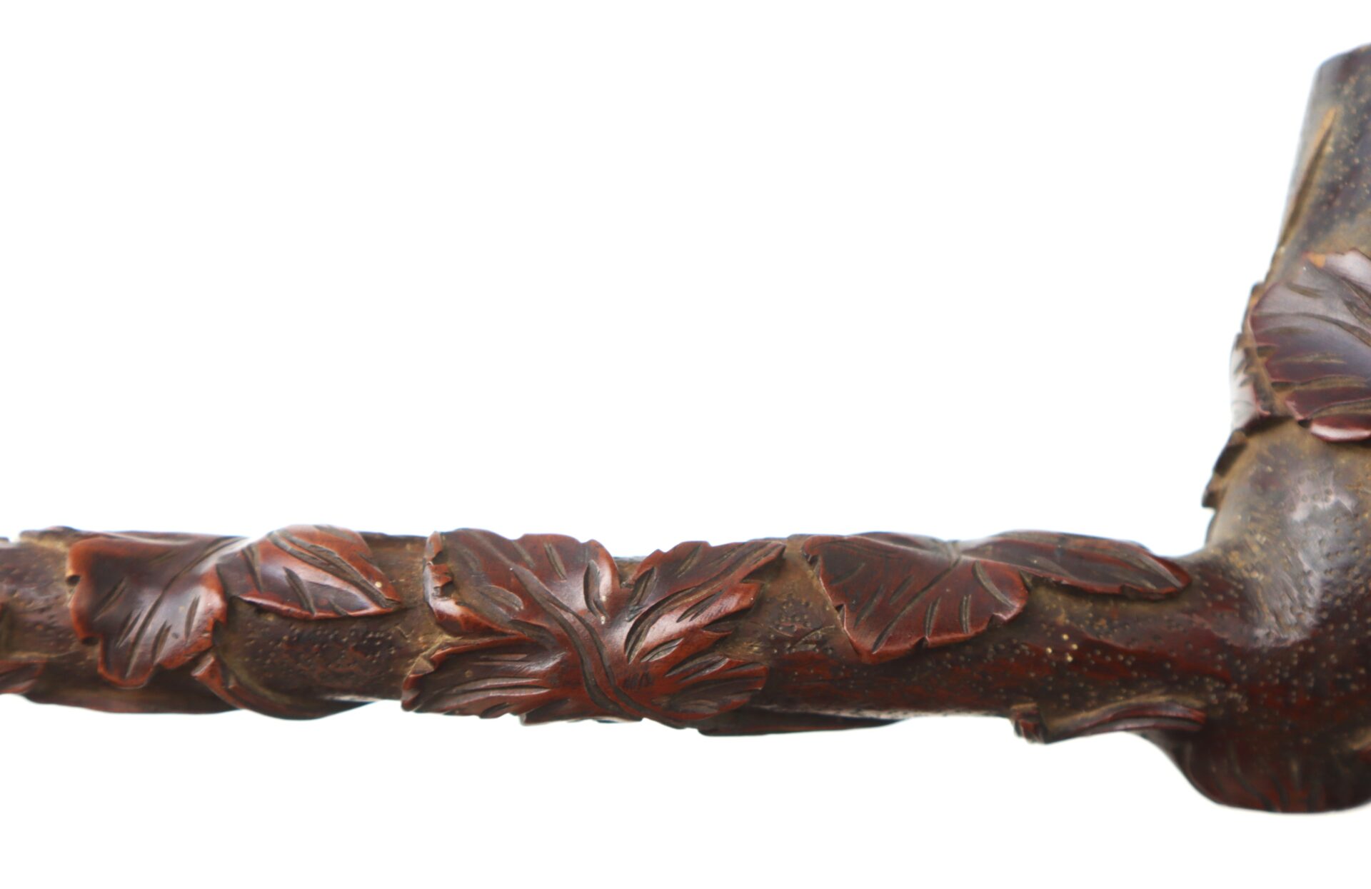 Close-up of a Hand-Carved Civil War-Era Pipe featuring an intricate grape leaf motif, displayed against a white background.