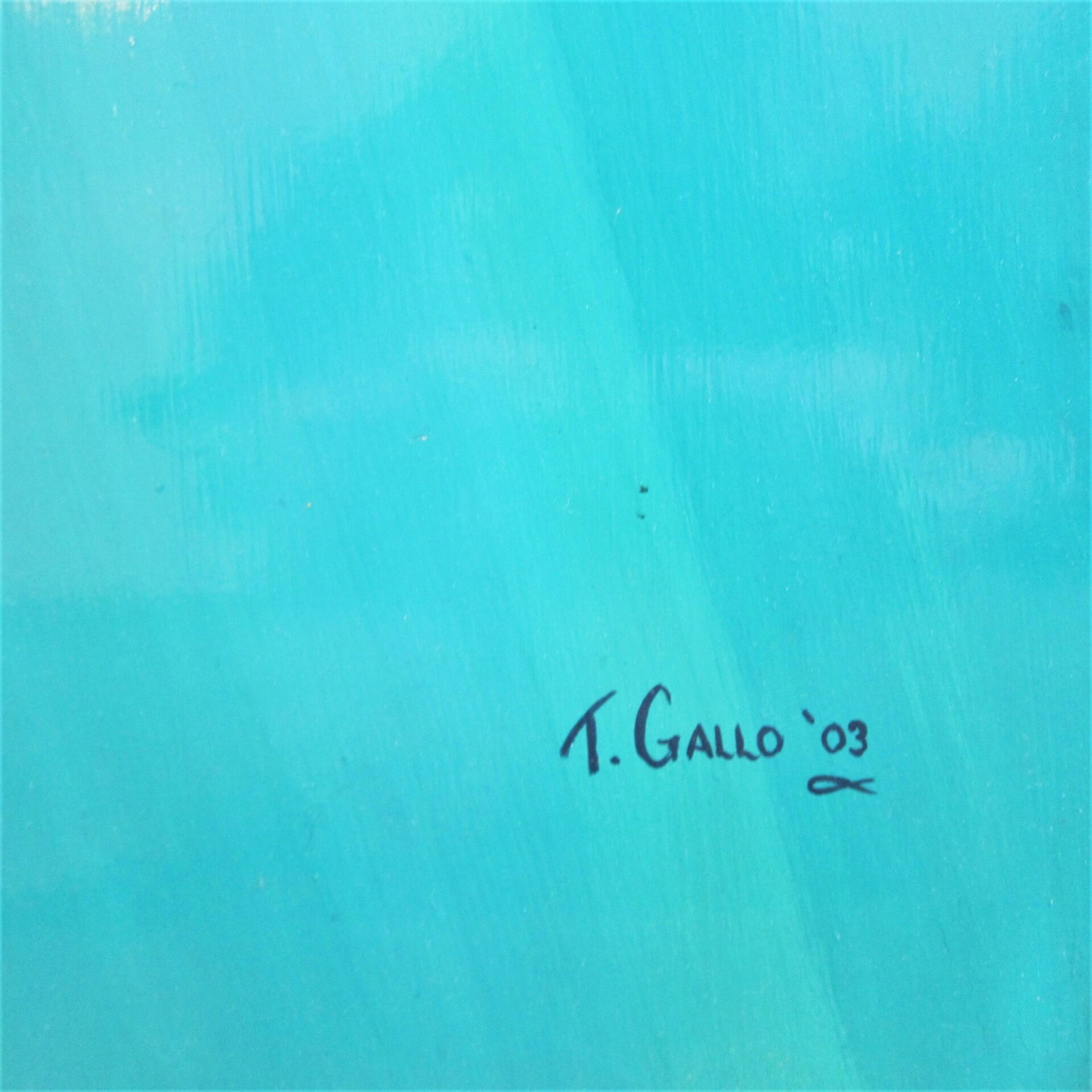 Blue painted surface with a handwritten signature reading "Tom Gallo '03" in black ink near the lower right corner of "Tom Gallo The Sinking of the Hunley.