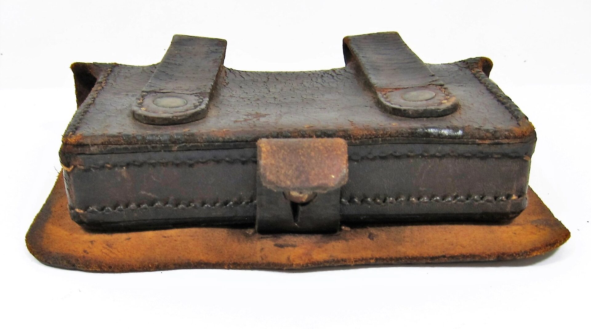 A Civil War Pistol Box, sold, featuring a worn brown leather pouch with a flap, two snap-button straps, and visible stitching, displayed against a white background.