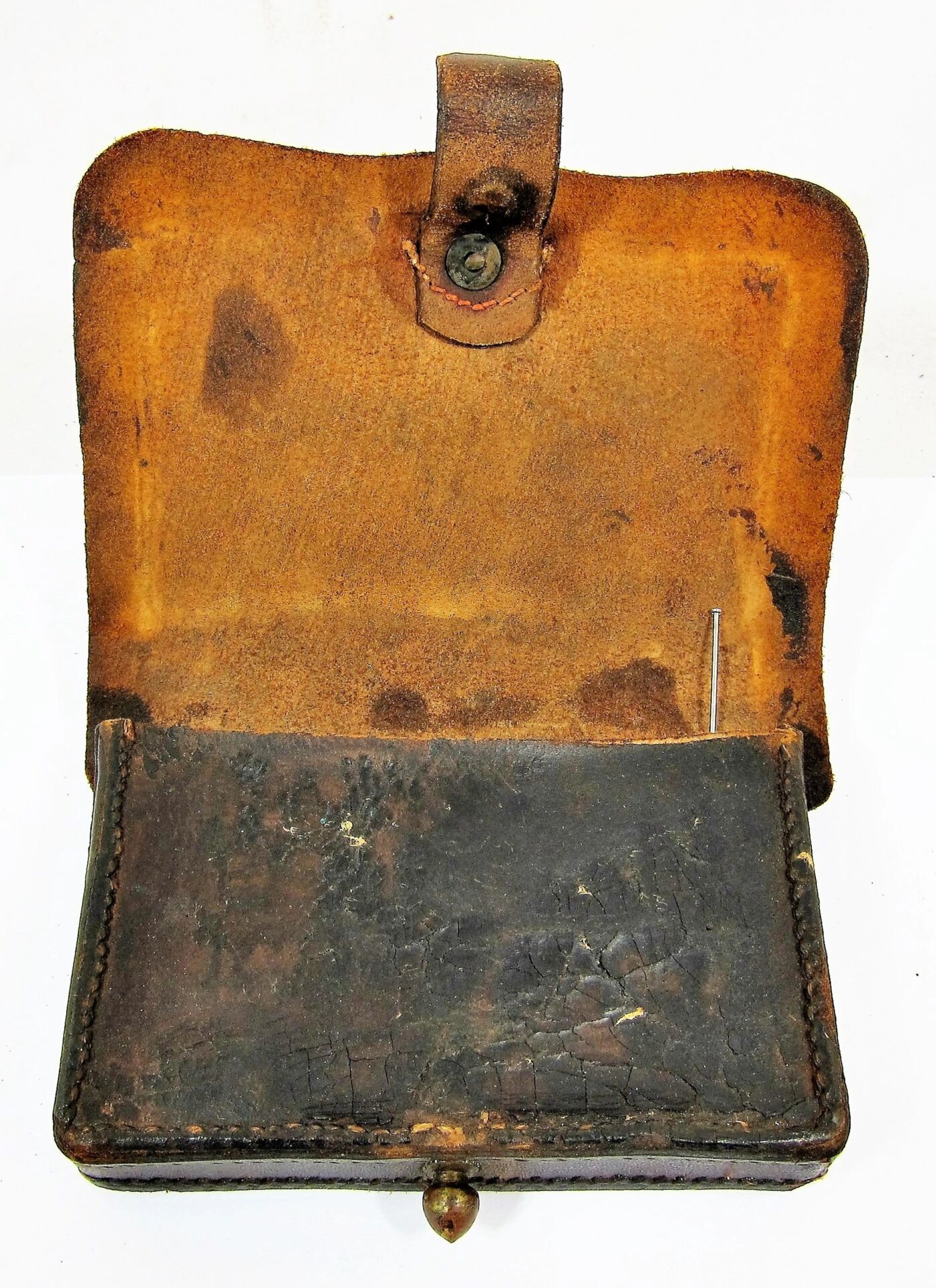 A vintage Civil War Pistol Box, featuring an aged brown leather pouch with a flap and button clasp, displays wear from use and sits against a white background.