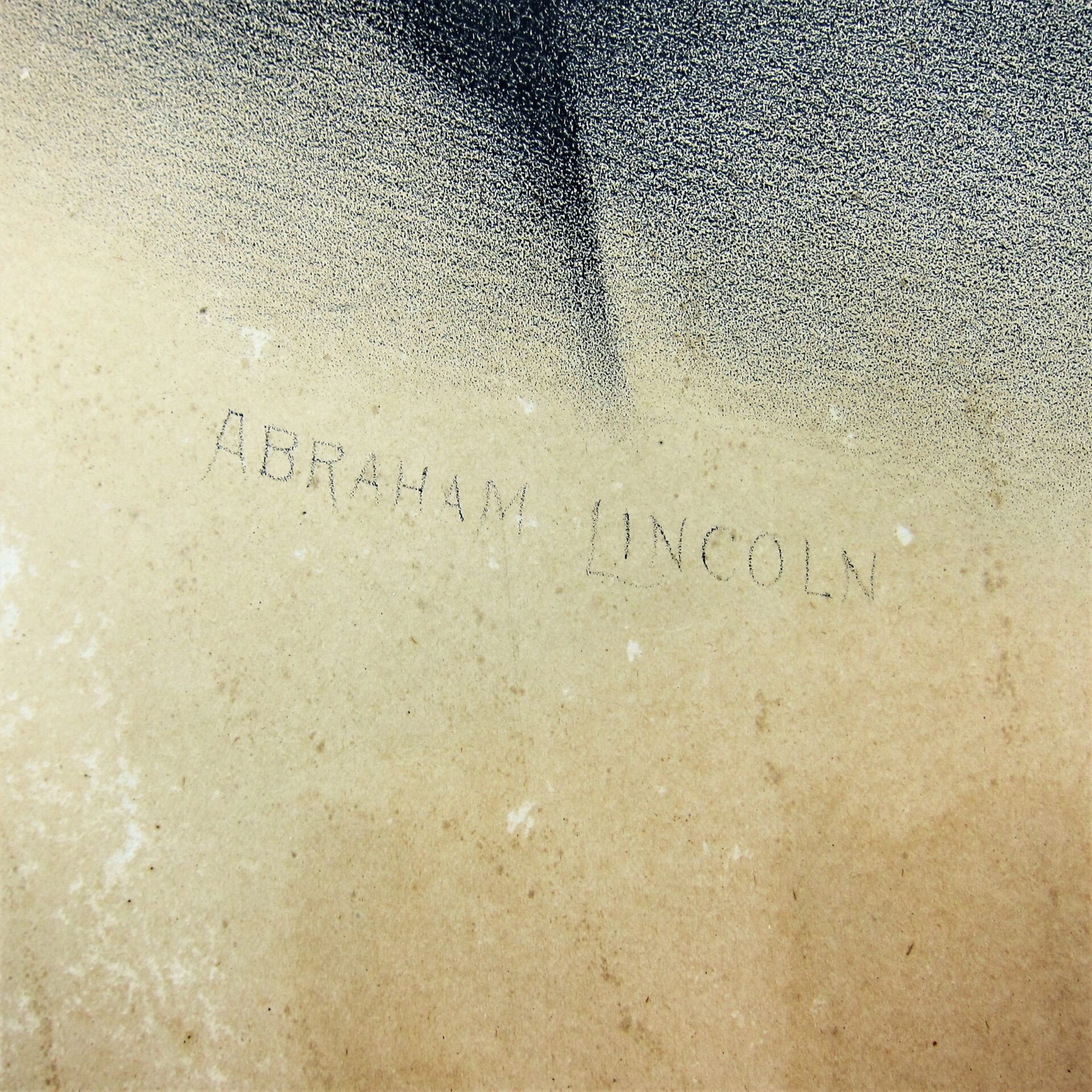 A close-up of a textured surface featuring "Abraham Lincoln by Kurtz and Allison / SOLD" faintly written in capital letters.