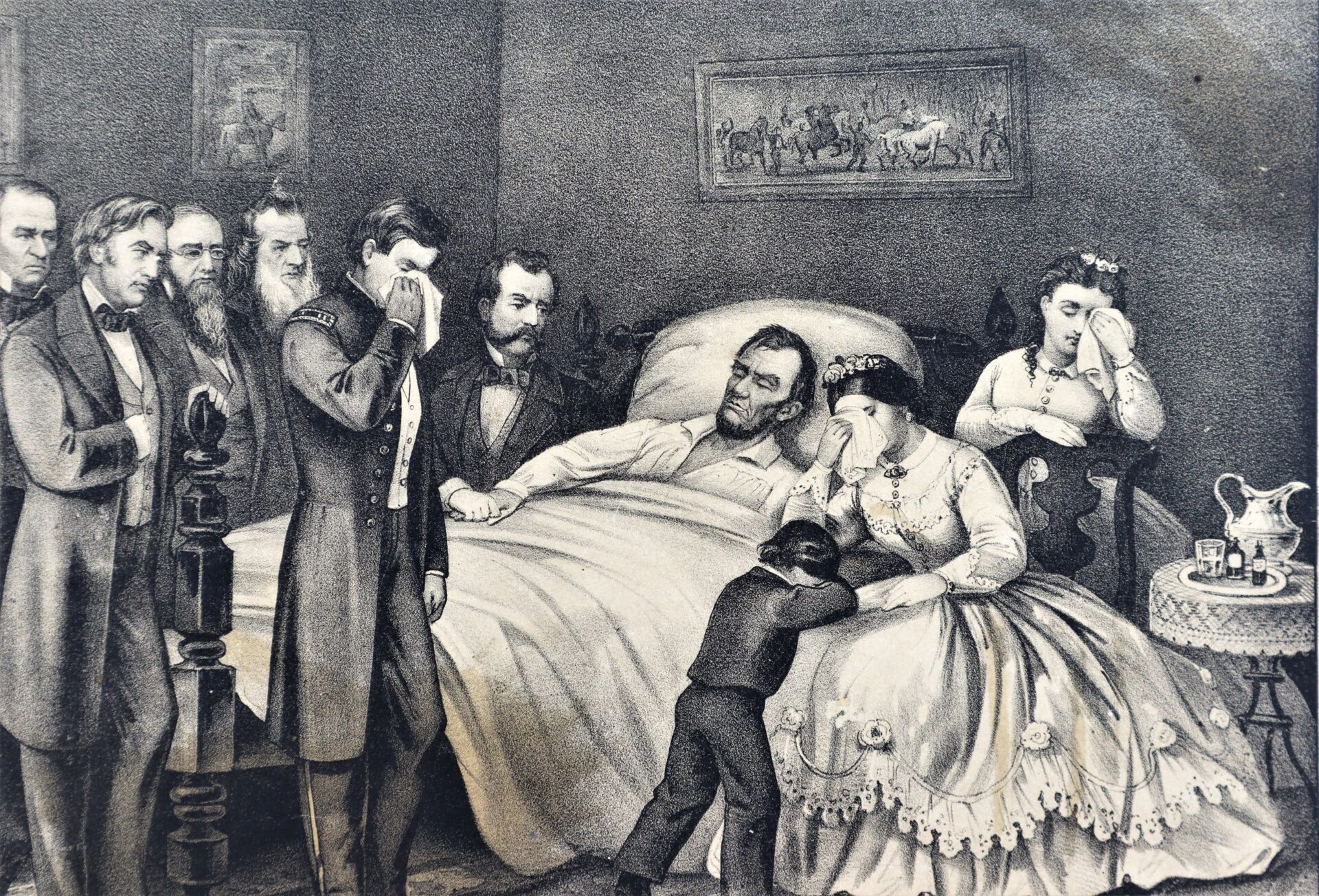 A group gathers around a man in bed in "Death of President Lincoln, The Nations Martyr"; a woman and child sit nearby with a table and jug in the dimly lit room, some mourners visibly grief-stricken.