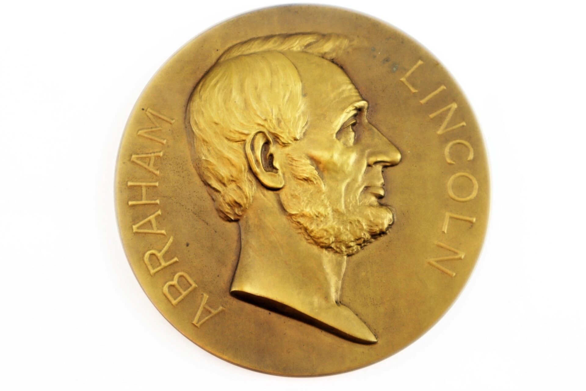 The Abraham Lincoln Medallion features a side profile of Abraham Lincoln with his name engraved around the edge.