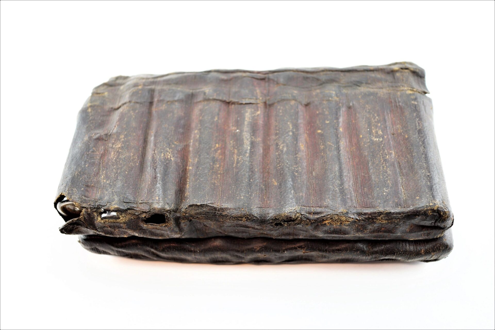 A closed Leather Apothecary Kit with a worn, dark brown leather cover and visible ridges is displayed against a white background.