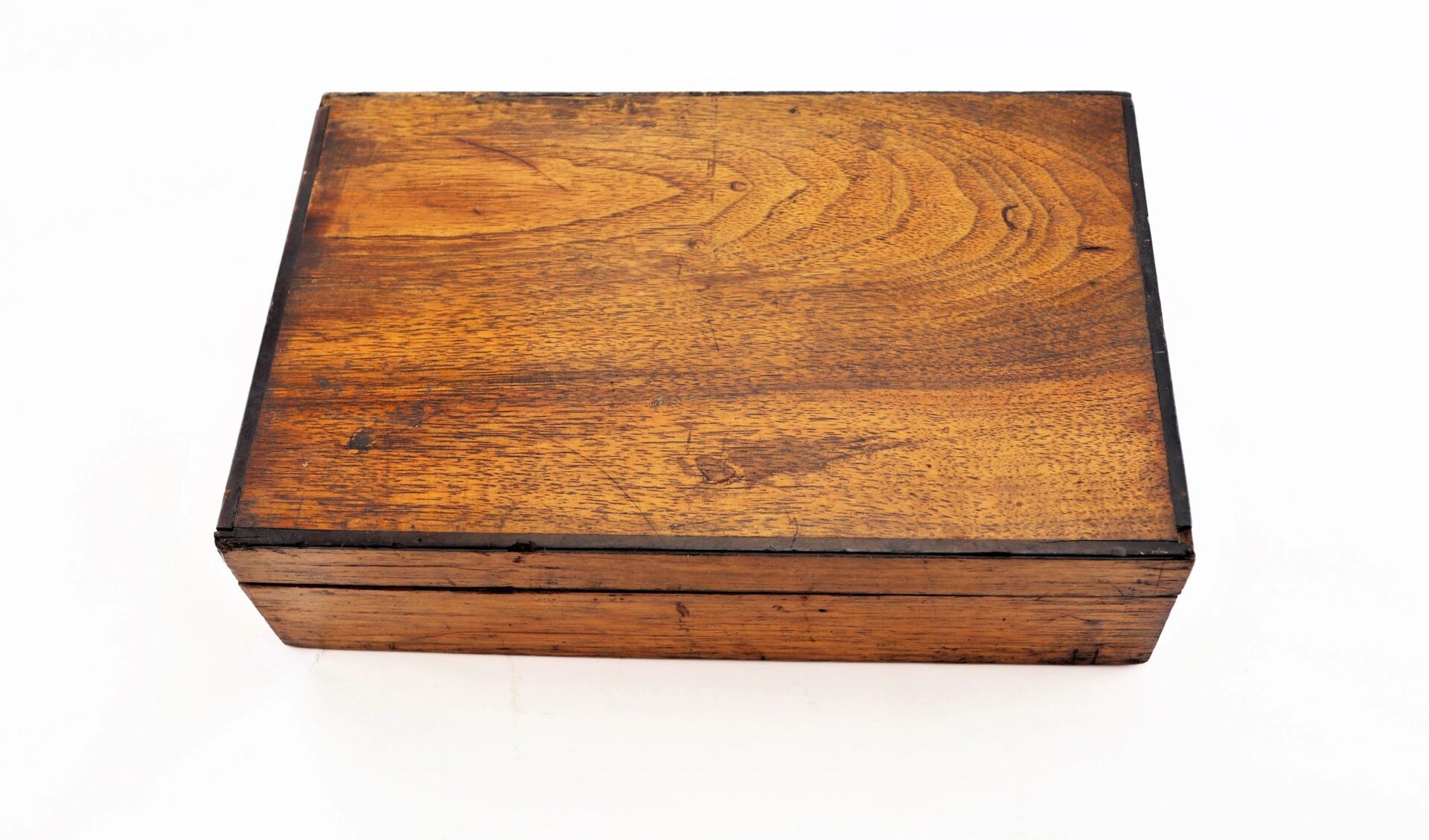A rectangular wooden box with a hinged lid, labeled "Personal Effects of Civil War Surgeon Dr. Seth L. Sprague / SOLD," closed and placed on a white surface.