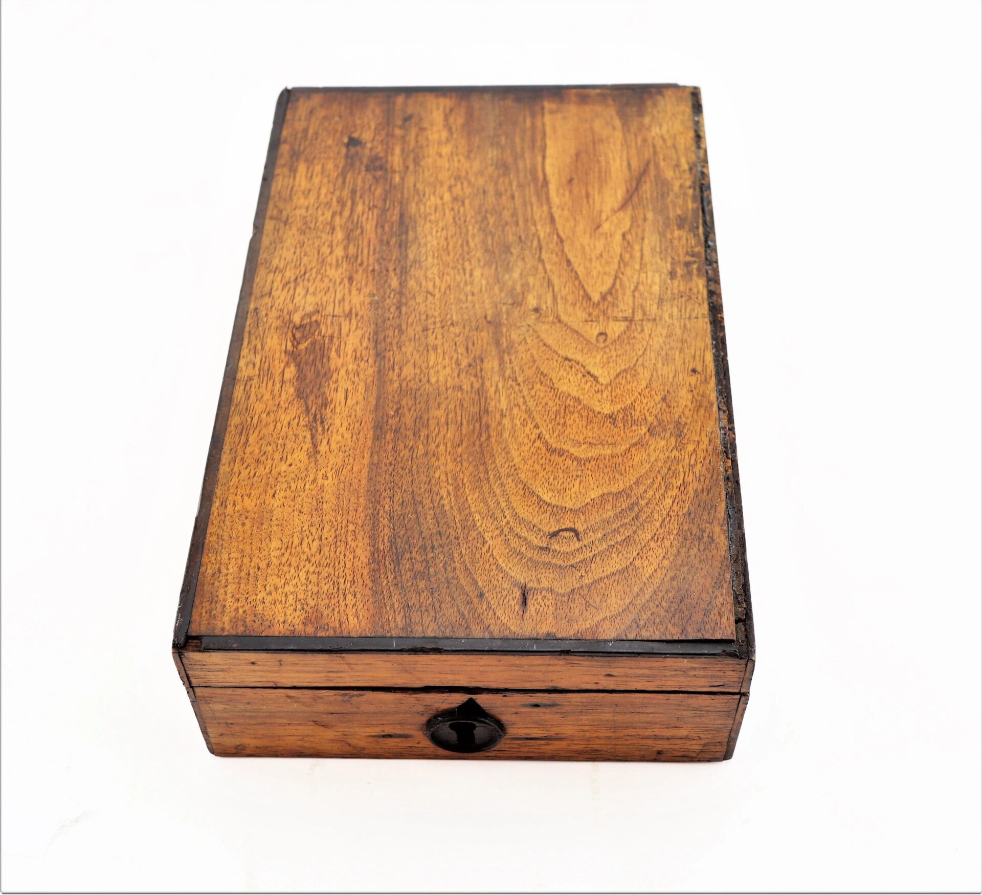 A rectangular wooden box from the Personal Effects of Civil War Surgeon Dr. Seth L. Sprague / SOLD, featuring a visible grain pattern and a central keyhole, is photographed against a white background.