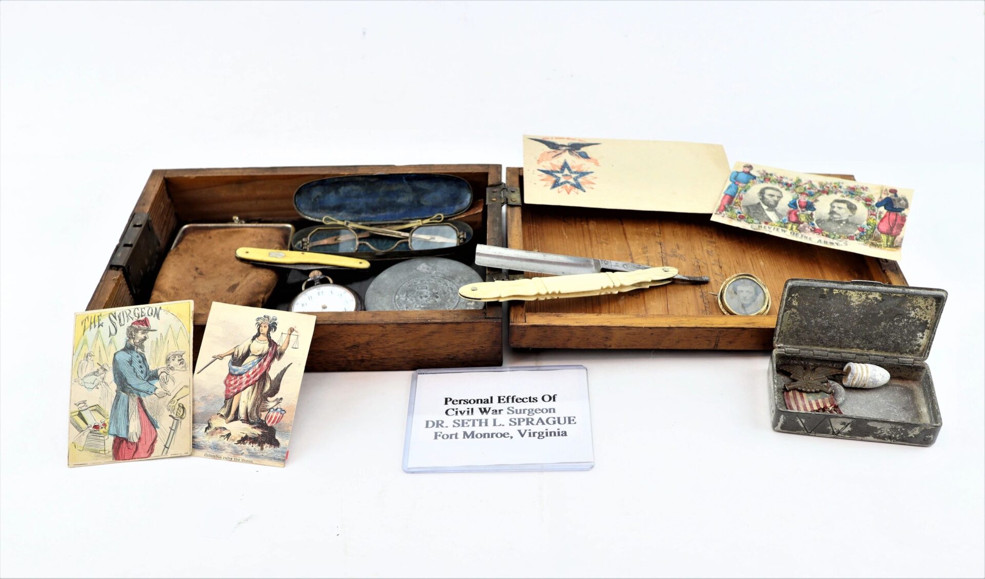 The Personal Effects of Civil War Surgeon Dr. Seth L. Sprague / SOLD include a wooden box containing his medical tools, postcards, pocket watch, and a small tin with buttons.