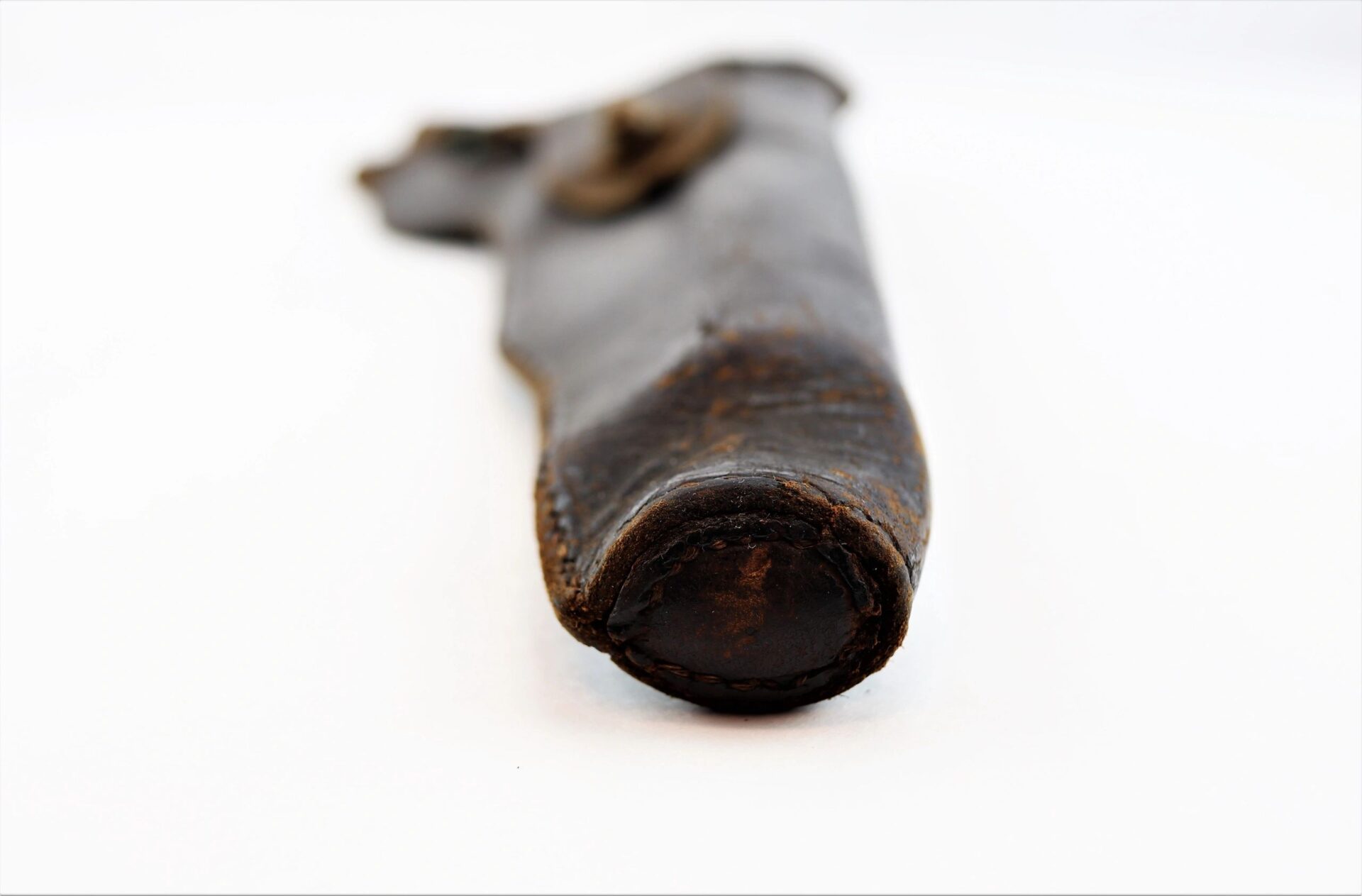 A close-up of a Civil War Flap Holster, showing its worn leather details, photographed against a plain white background.