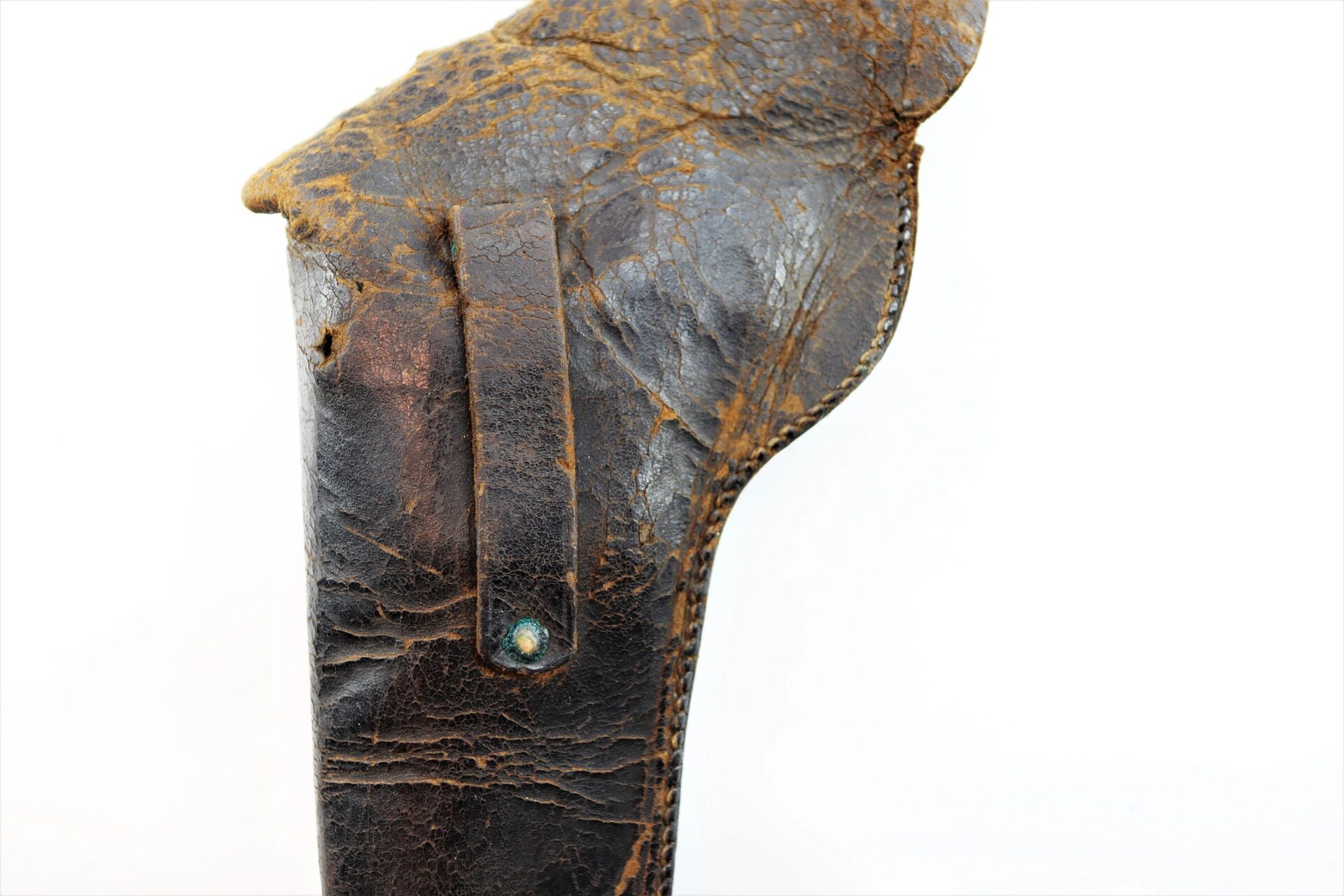 Close-up of a worn Civil War Flap Holster, dark brown leather with visible cracks, creases, and a greenish metal rivet shown against a white background. Item is marked as SOLD.