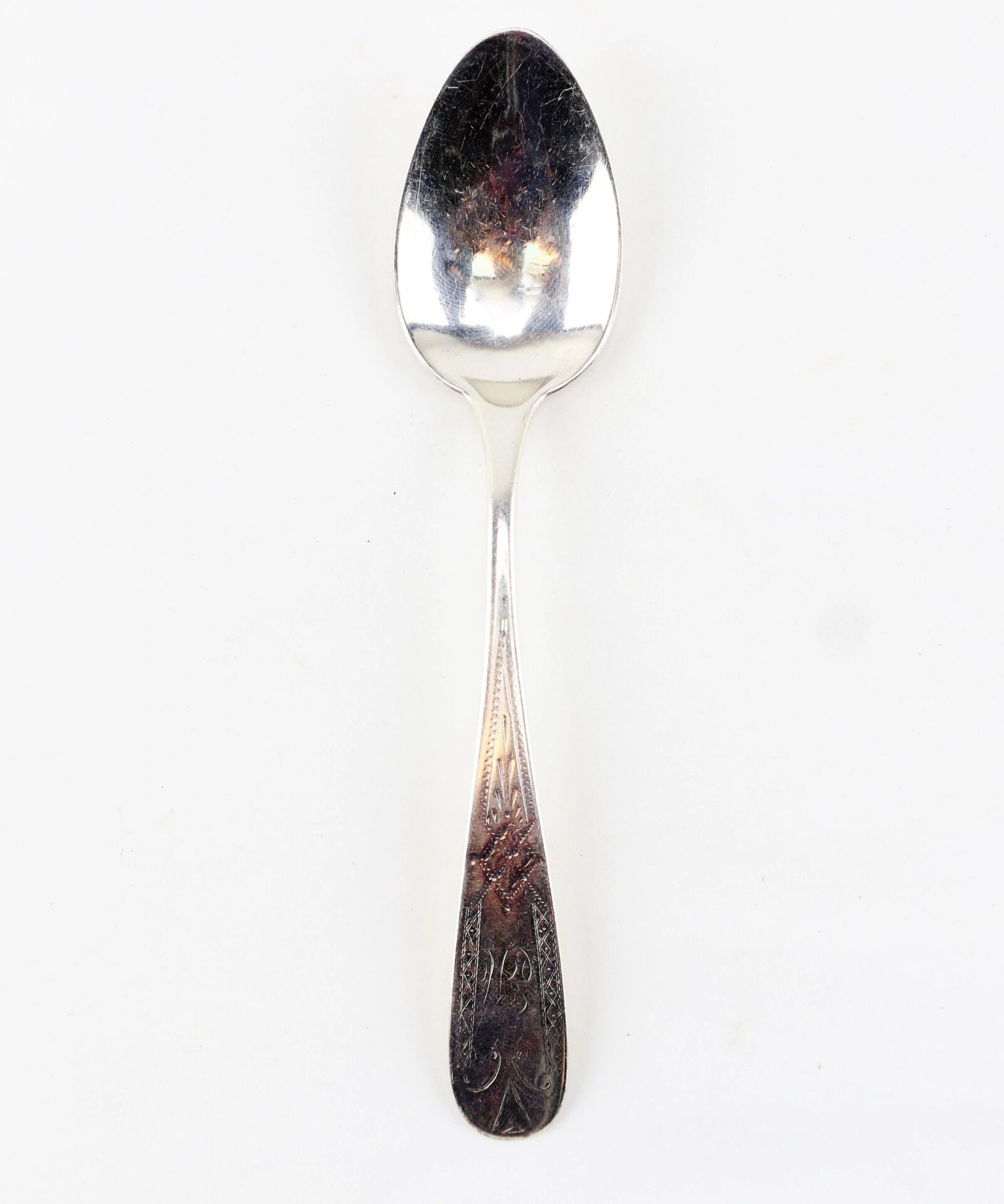 A Civil War silver teaspoon with an ornate handle design, photographed against a plain white background.