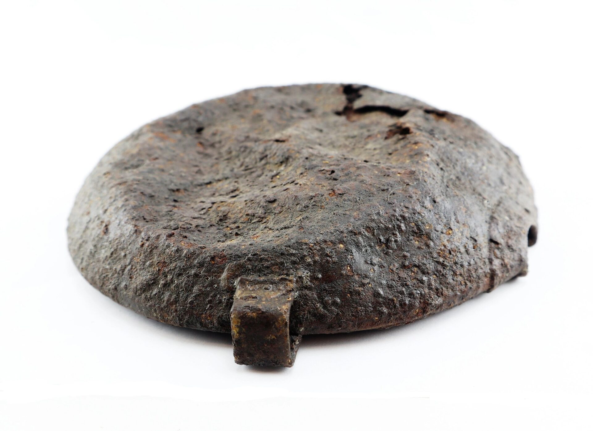 The Battlefield Relic Canteen, a round rusted metal item with a small rectangular tab on one side, is shown against a white background. Sold.
