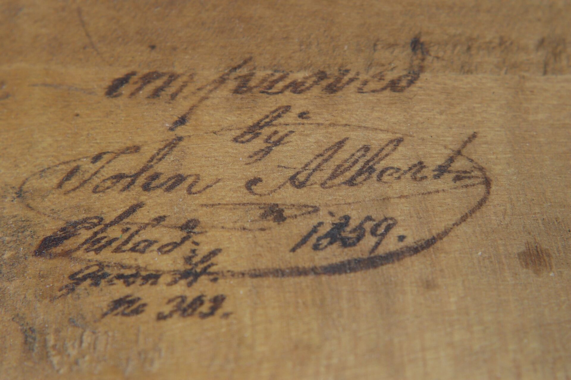 Close-up of handwritten label inside Violin / Sold, reading "improved by John Albert, dated 1859," with some partially legible text and numbers below.