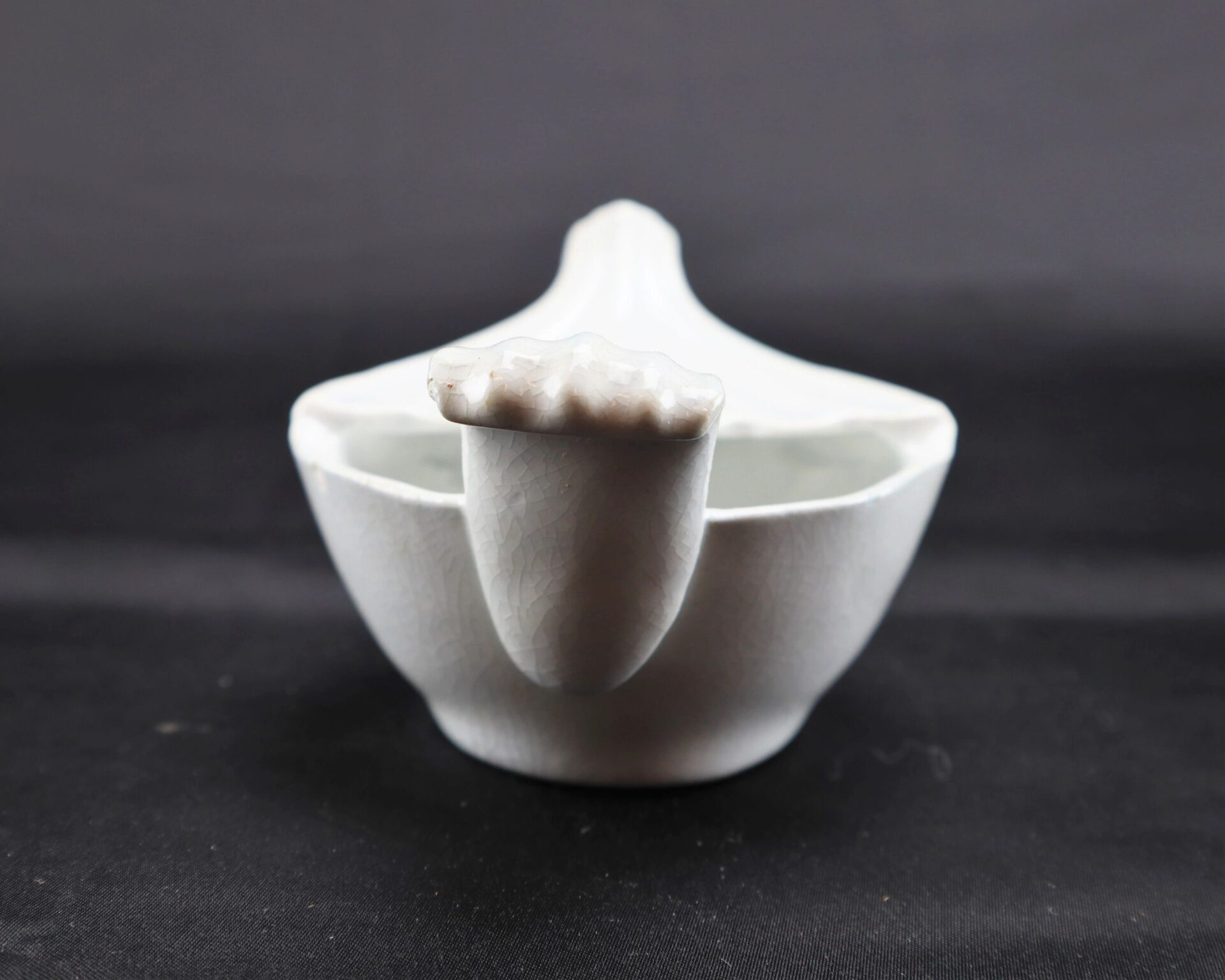 Invalid Feeder / SOLD: White ceramic bowl with lid and protruding handle, displayed on a plain dark background.