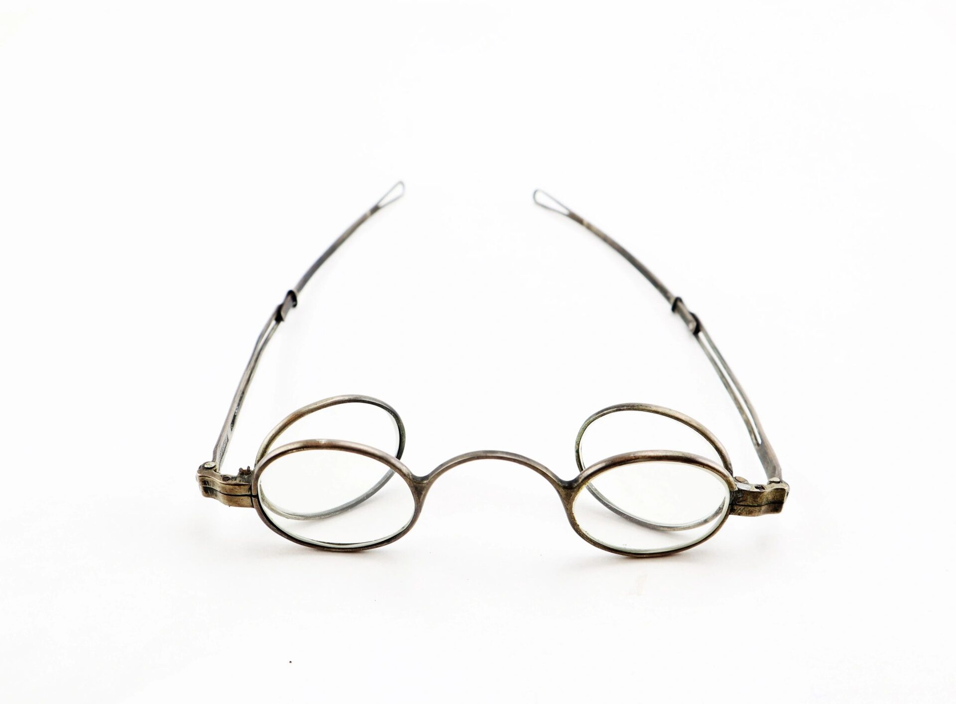 A pair of Civil War Eyeglasses with oval lenses, wire frames, and side loop attachments, displayed on a white background.