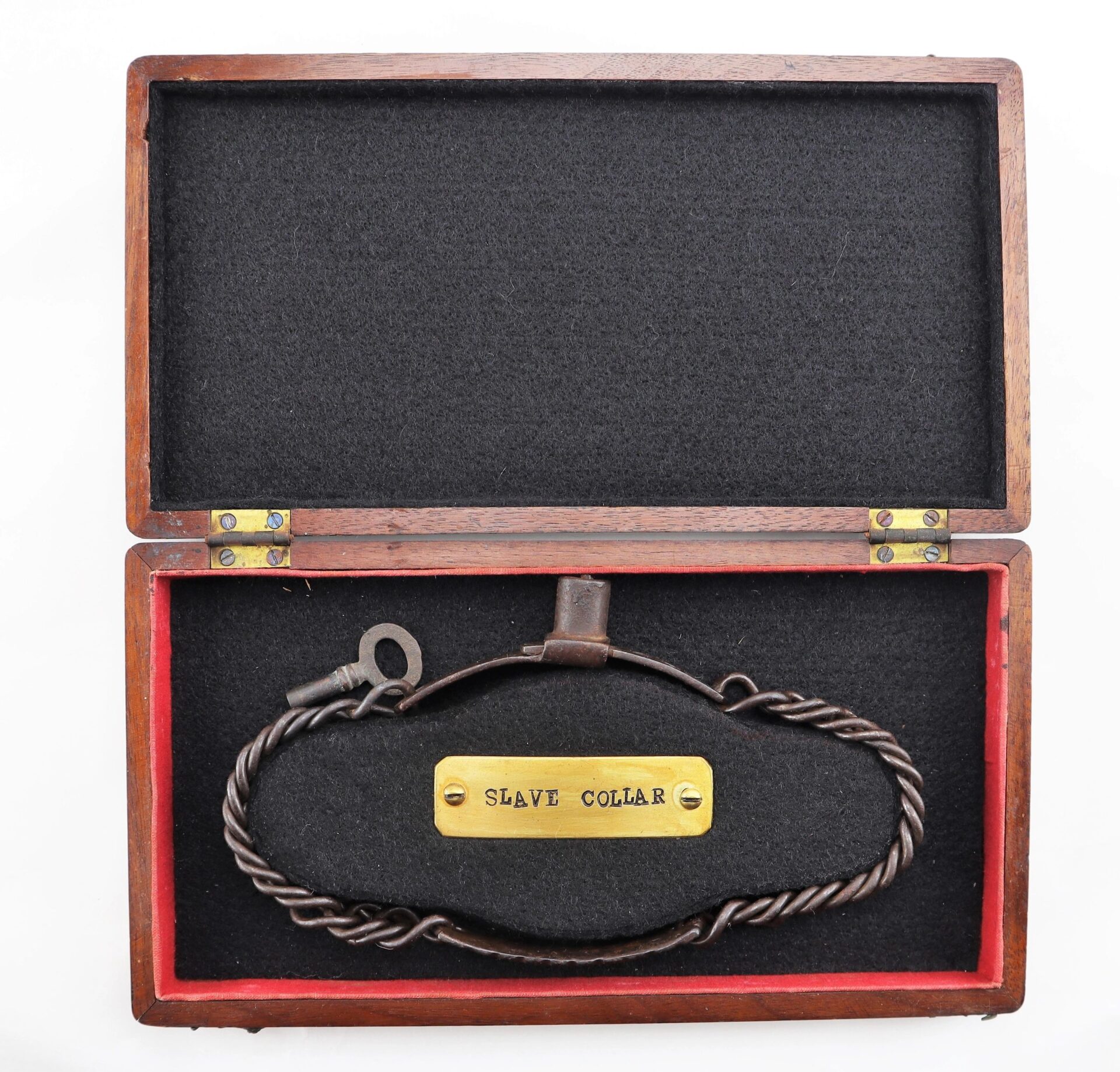 An open wooden box displays the "Civil War Dog / Slave Collar / Sold," featuring a metal collar with a key and a brass plate labeled "SLAVE COLLAR" on black velvet lining.