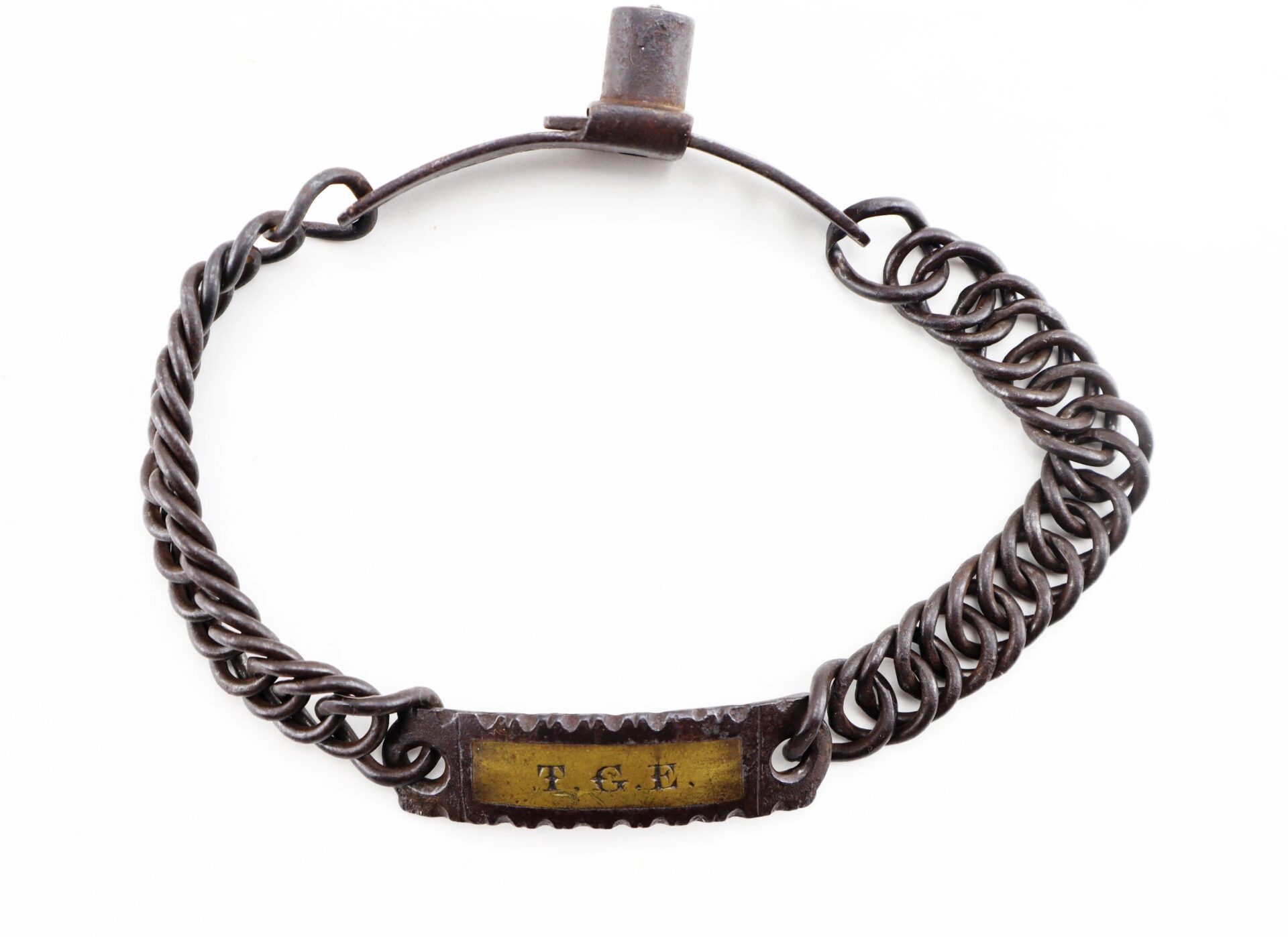 A Civil War dog/slave collar with a metal chain, rectangular nameplate engraved "T.G.L.," and clasp closure.