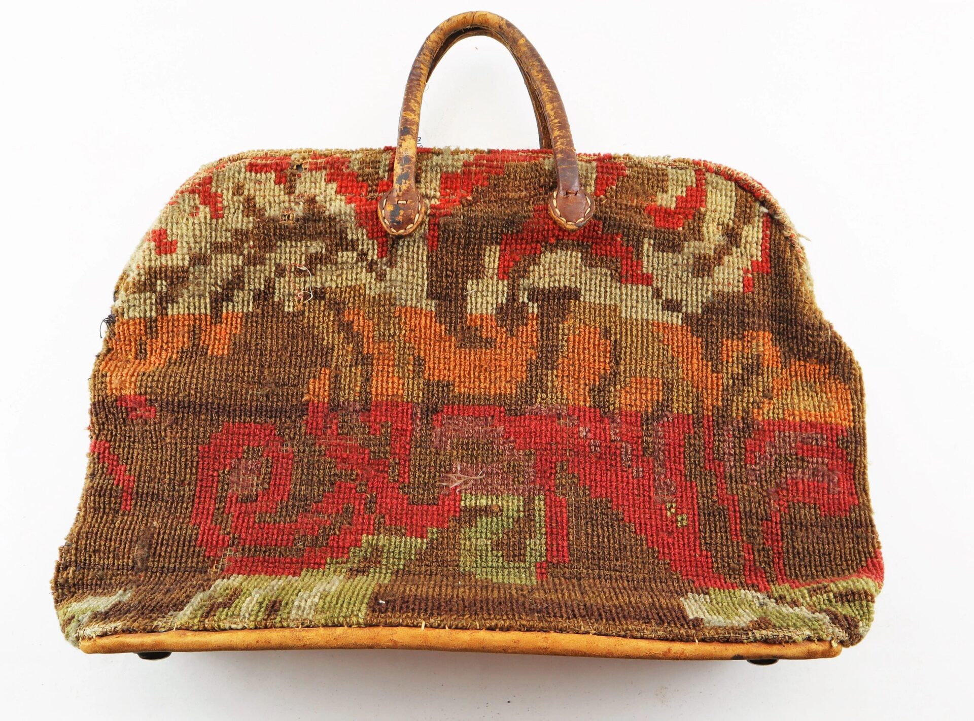 Civil War "Carpet Bag" featuring leather handles and a colorful patterned tapestry in brown, red, orange, and green on white. Sold.