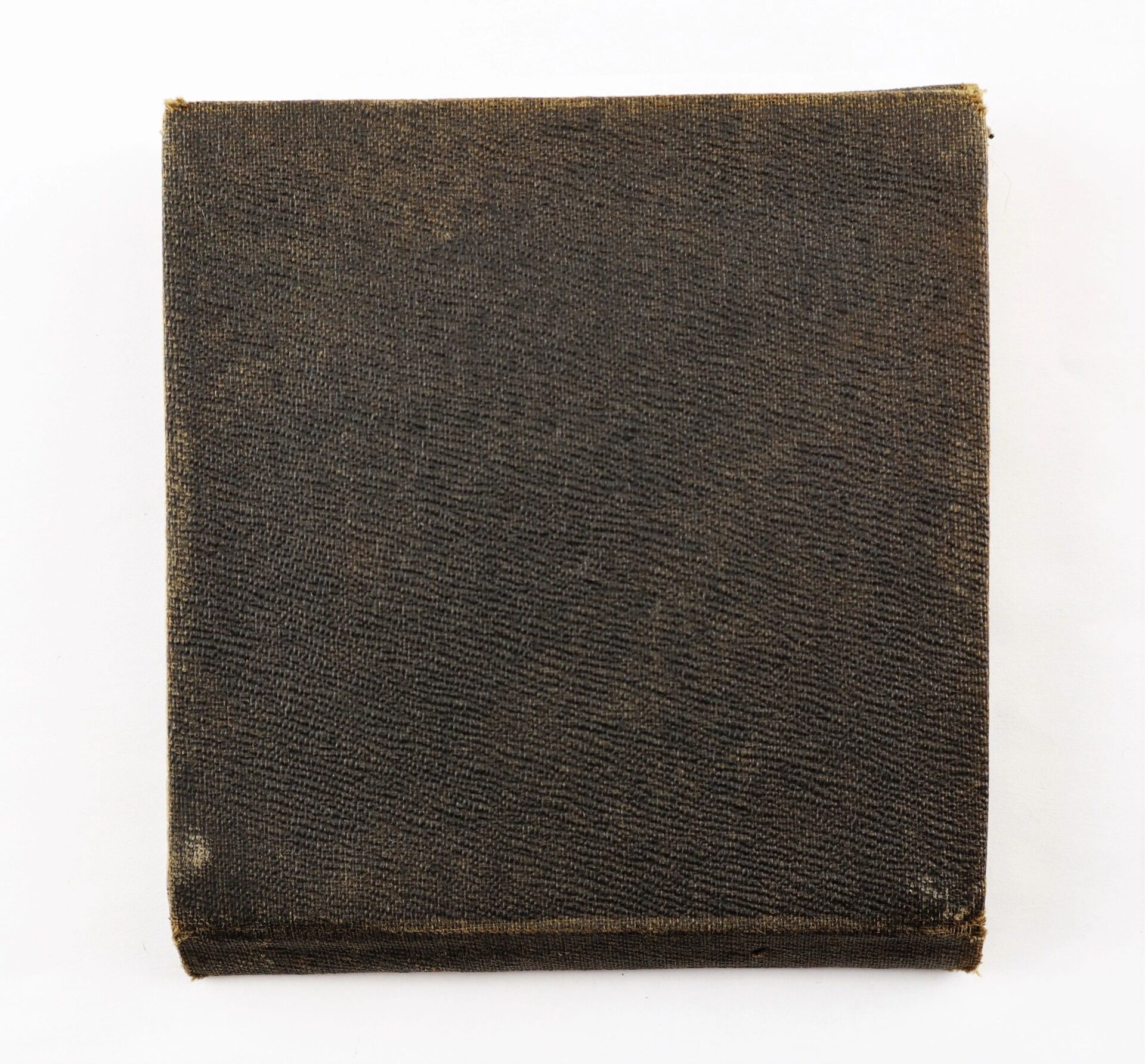 A closed, square, dark brown textured case with slightly worn edges containing the Abraham Lincoln Centennial Medal / Sold, placed on a white background.
