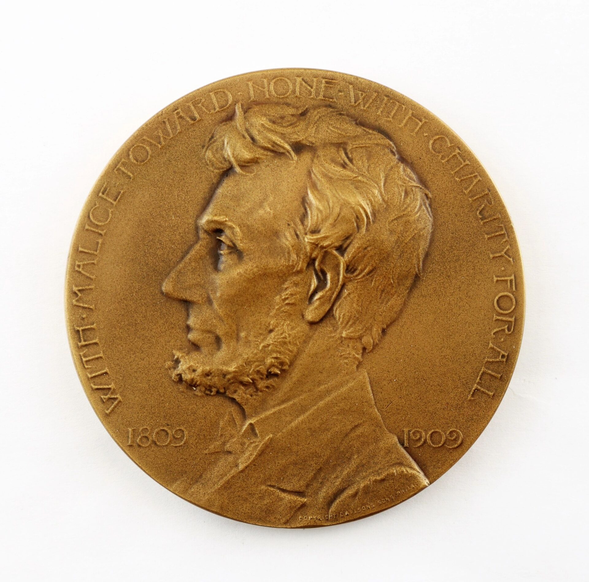 Abraham Lincoln Centennial Medal: Bronze medallion with left-facing Lincoln profile and the inscription "With malice toward none, with charity for all. 1809 1909." Sold.