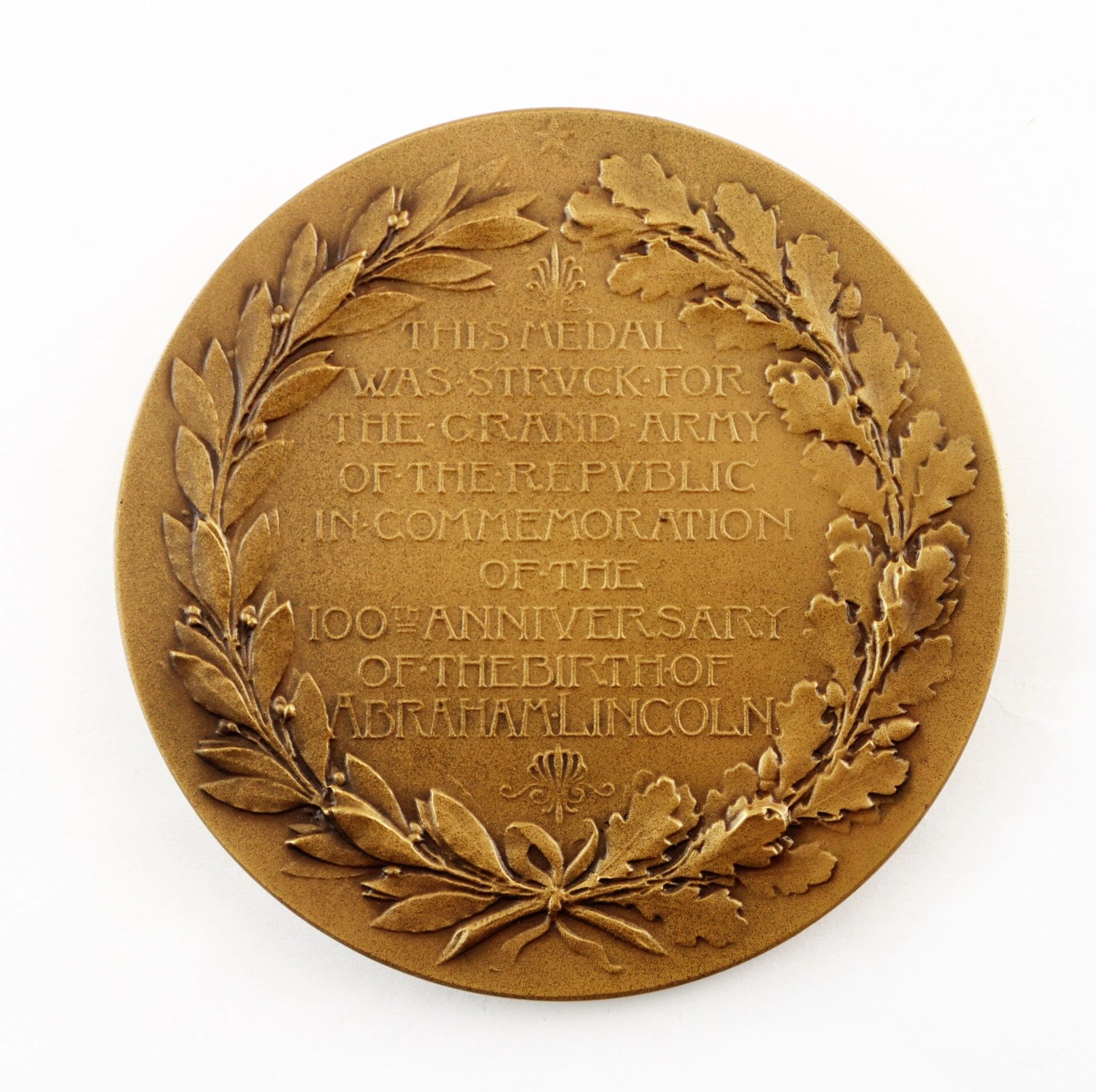 The Abraham Lincoln Centennial Medal, featuring laurel and oak wreaths with a commemorative inscription, was issued for the Grand Army of the Republic to mark Lincoln’s 100th birthday. / Sold.