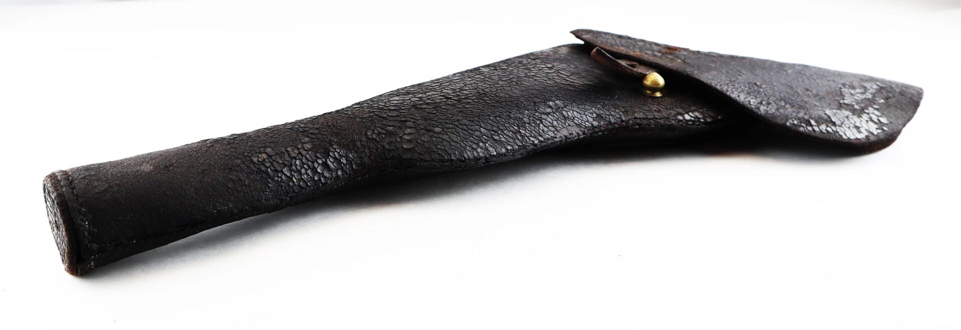 A worn dark brown Colt Dragoon Holster, featuring a brass-buttoned flap, is displayed against a white background.
