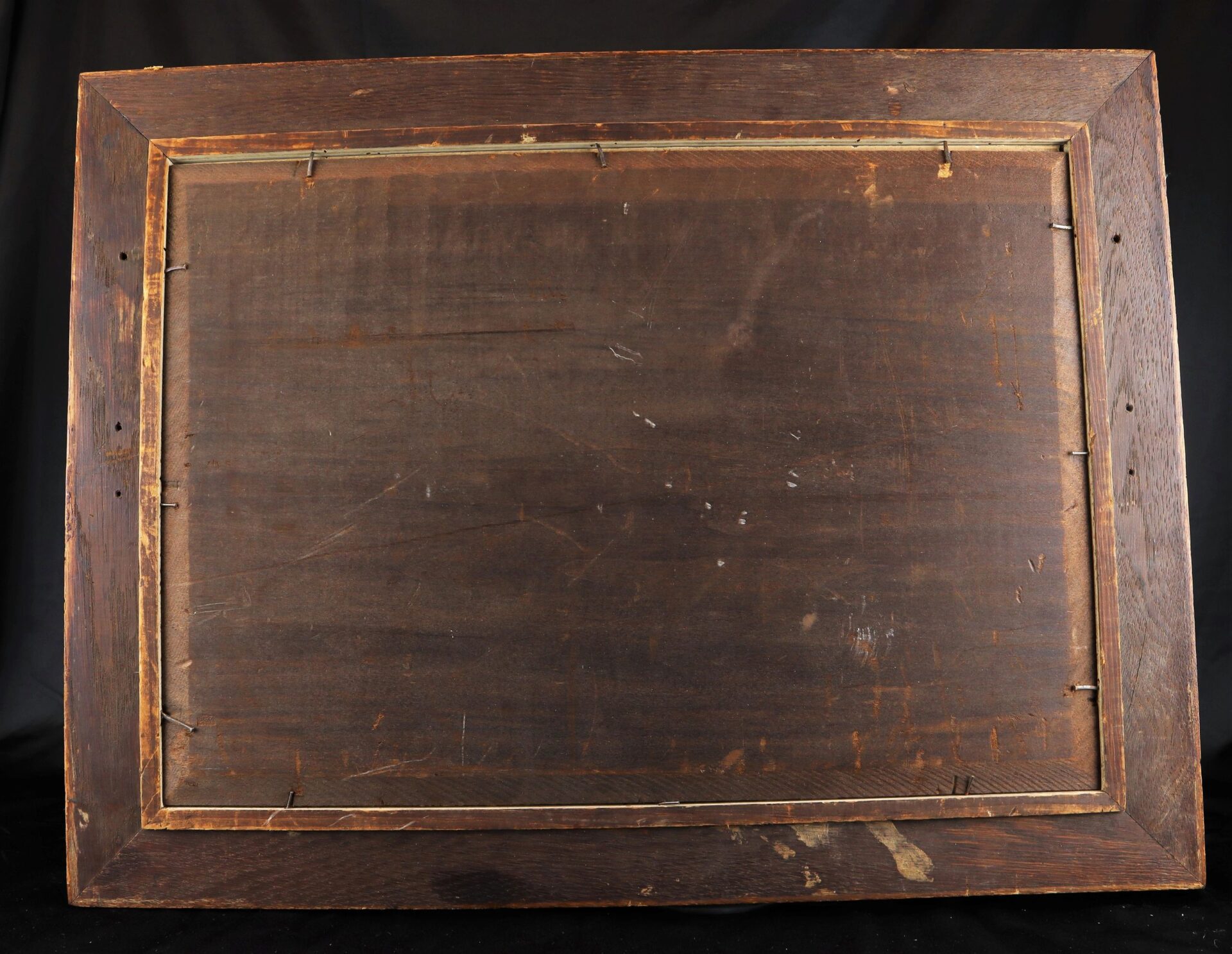 The back of the "Battle of Mobile Bay" rectangular wooden picture frame shows visible scratches, wire fasteners, and signs of wear against a black background.