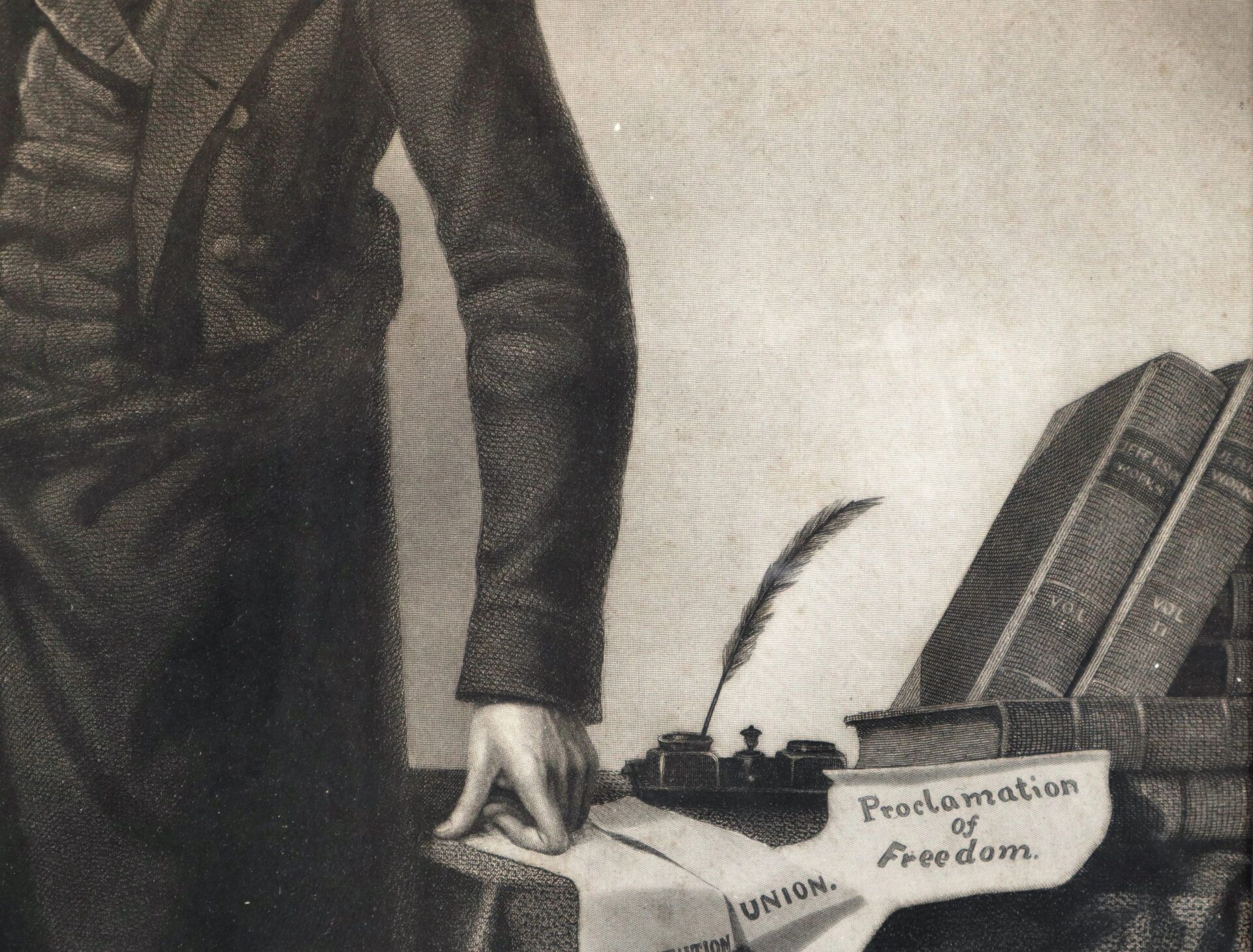 A person in formal attire stands beside a table with books, an inkwell, a quill, and a “Proclamation of Freedom” document. Product: Abraham Lincoln / SOLD.