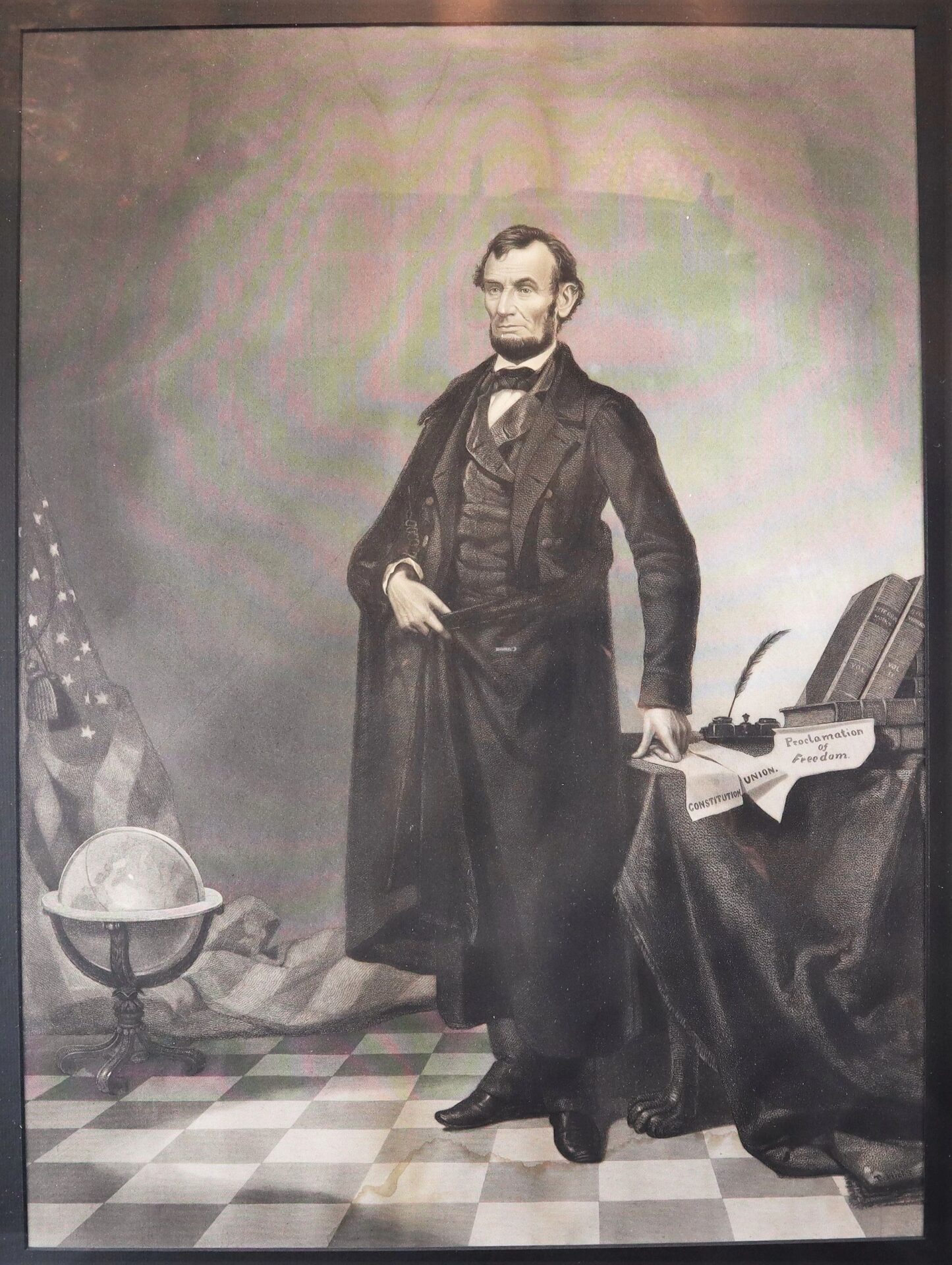 Abraham Lincoln, in formal 19th-century attire, stands beside a table with books and papers labeled "Constitution" and "Proclamation of Freedom," with an American flag and globe behind him. Product Name: Abraham Lincoln / SOLD.
