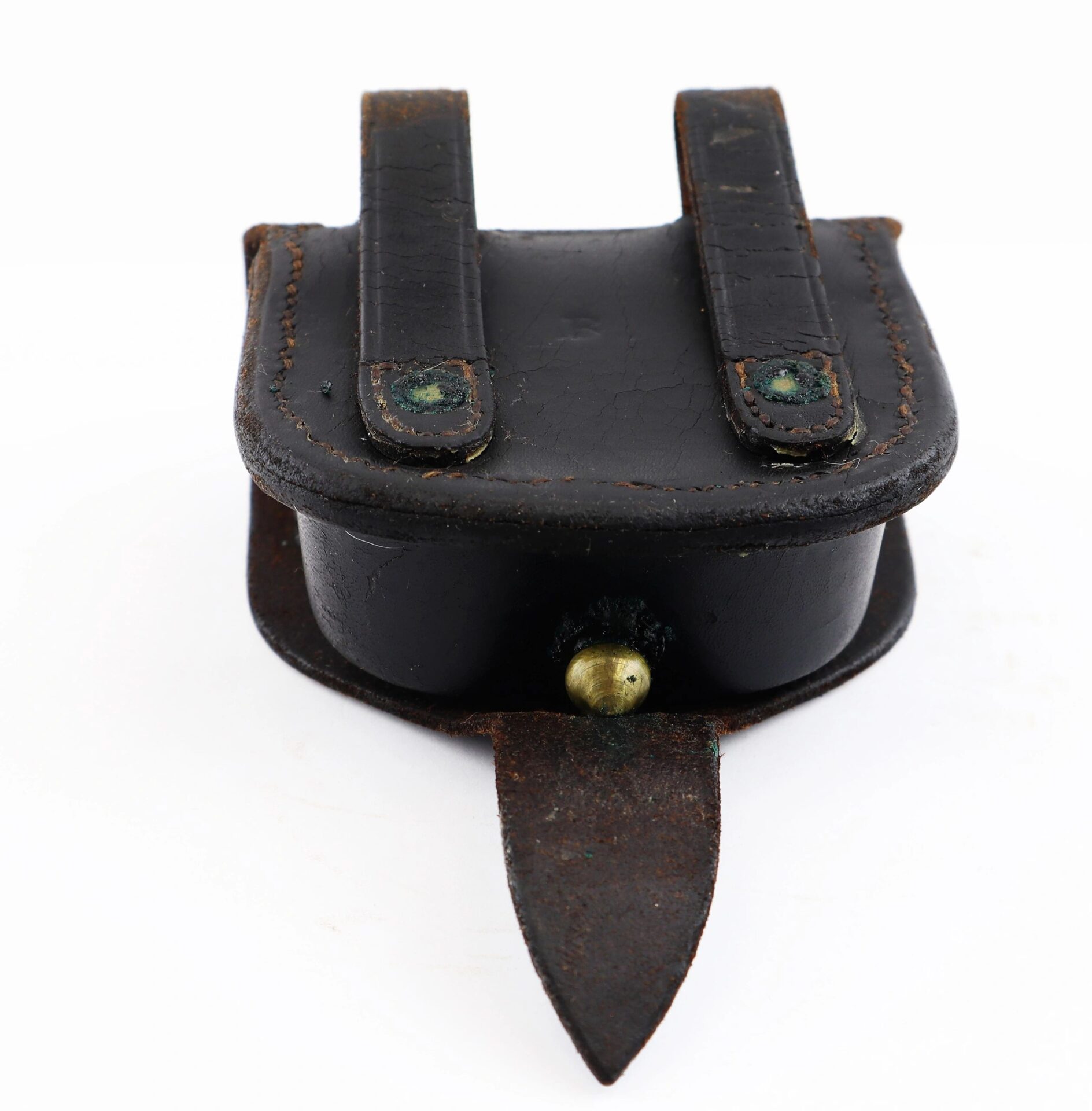 A Civil War Percussion Cap Box with two back belt loops, a brass button clasp, and a pointed leather flap at the bottom. SOLD.