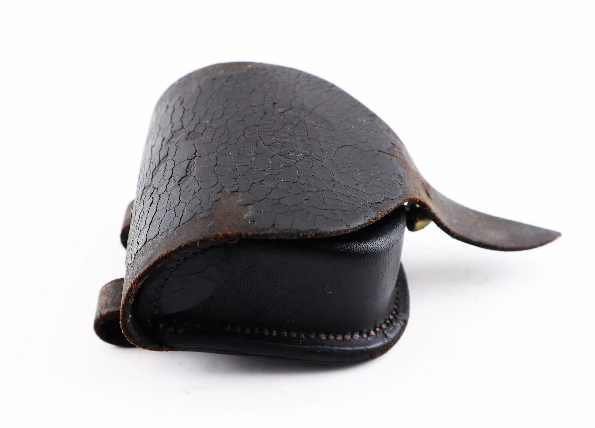 A small, closed Civil War Percussion Cap Box with a dark brown, cracked leather texture and flap cover, photographed on a white background.