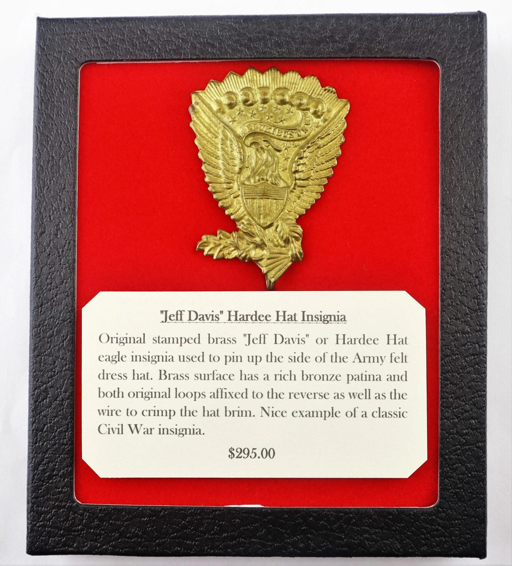A framed "Jeff Davis" Hardee Hat Insignia (SOLD) with a descriptive card of its features and history, displayed against a red background.