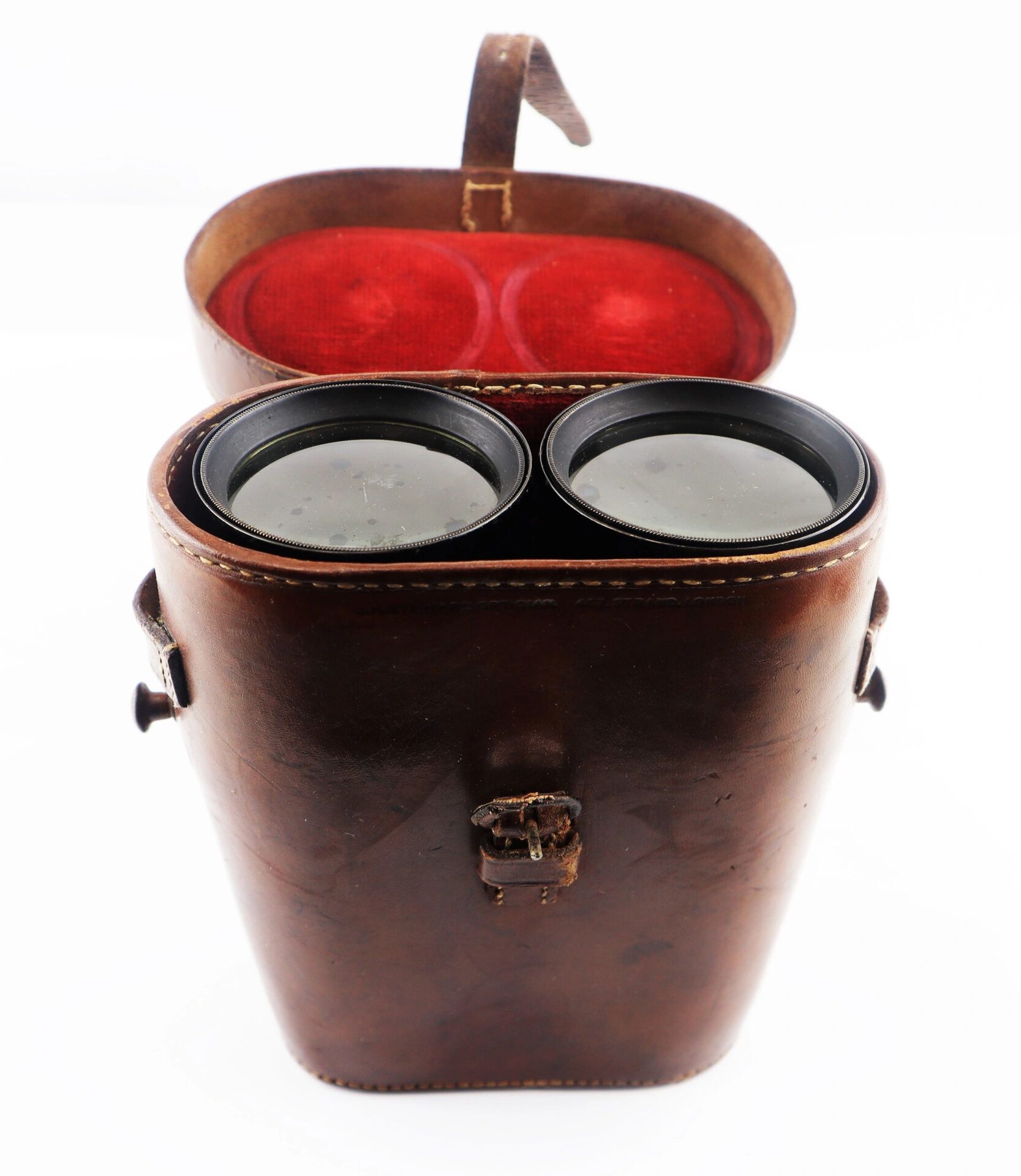 A pair of Civil War Field Glasses in a brown leather case with the lid open, revealing a red interior lining.