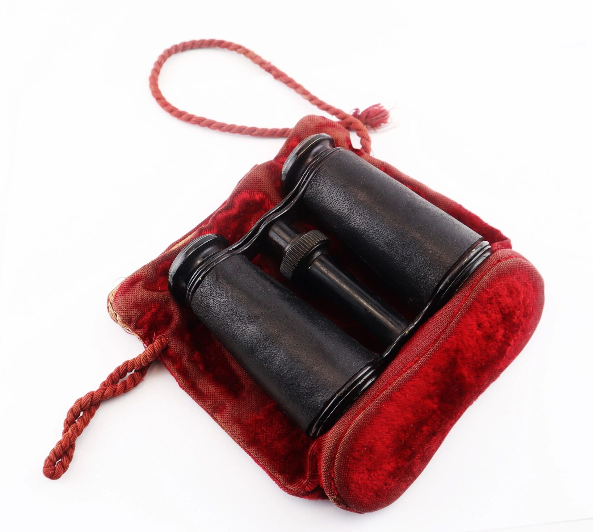 A pair of Civil War Era Field Glasses by Tiffany & Co. New York in a red velvet case with red cord, displayed against a white background.