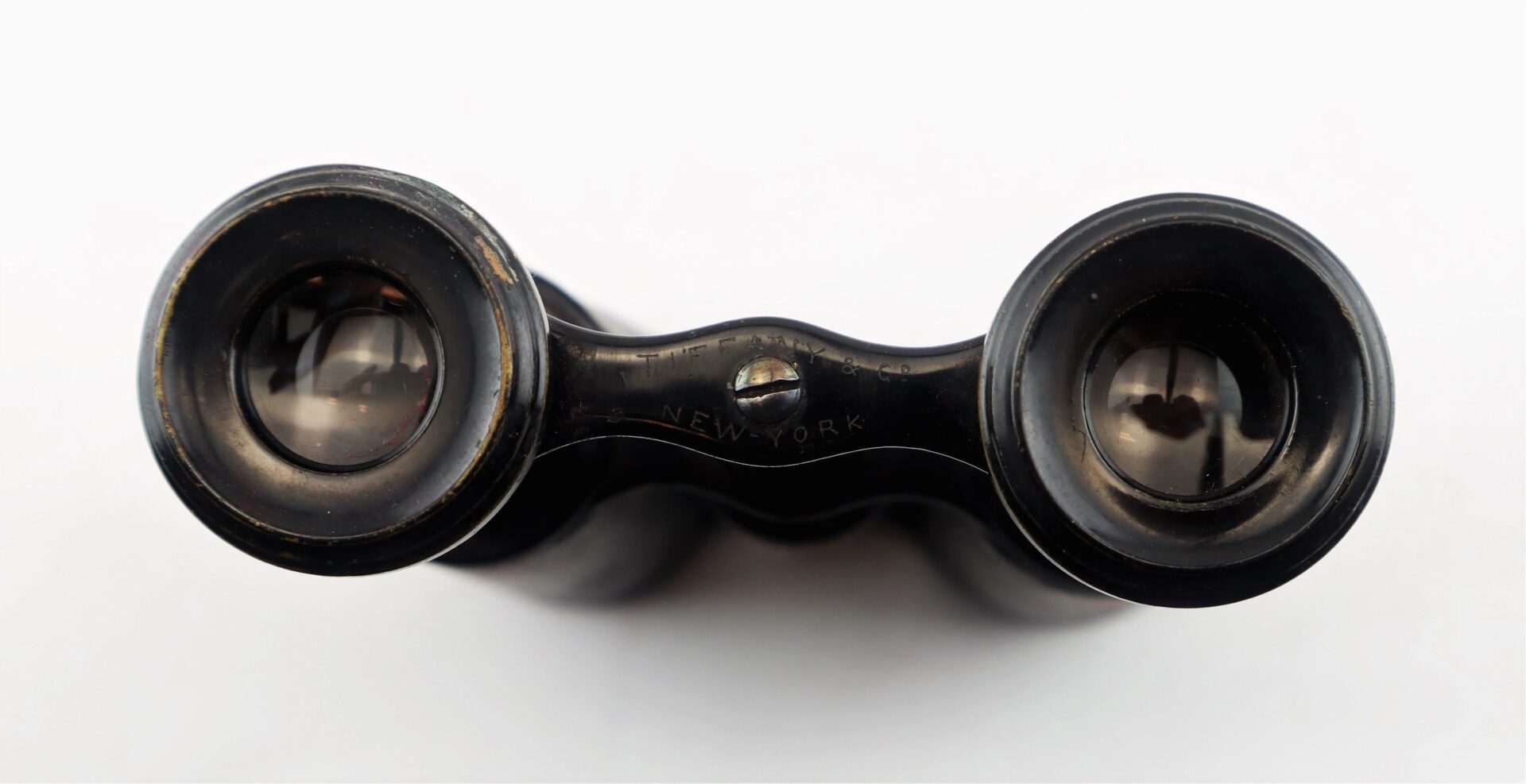 Close-up view of the eyepieces of Civil War Era Field Glasses by Tiffany & Co. New York, vintage black binoculars displayed on a white background / SOLD.