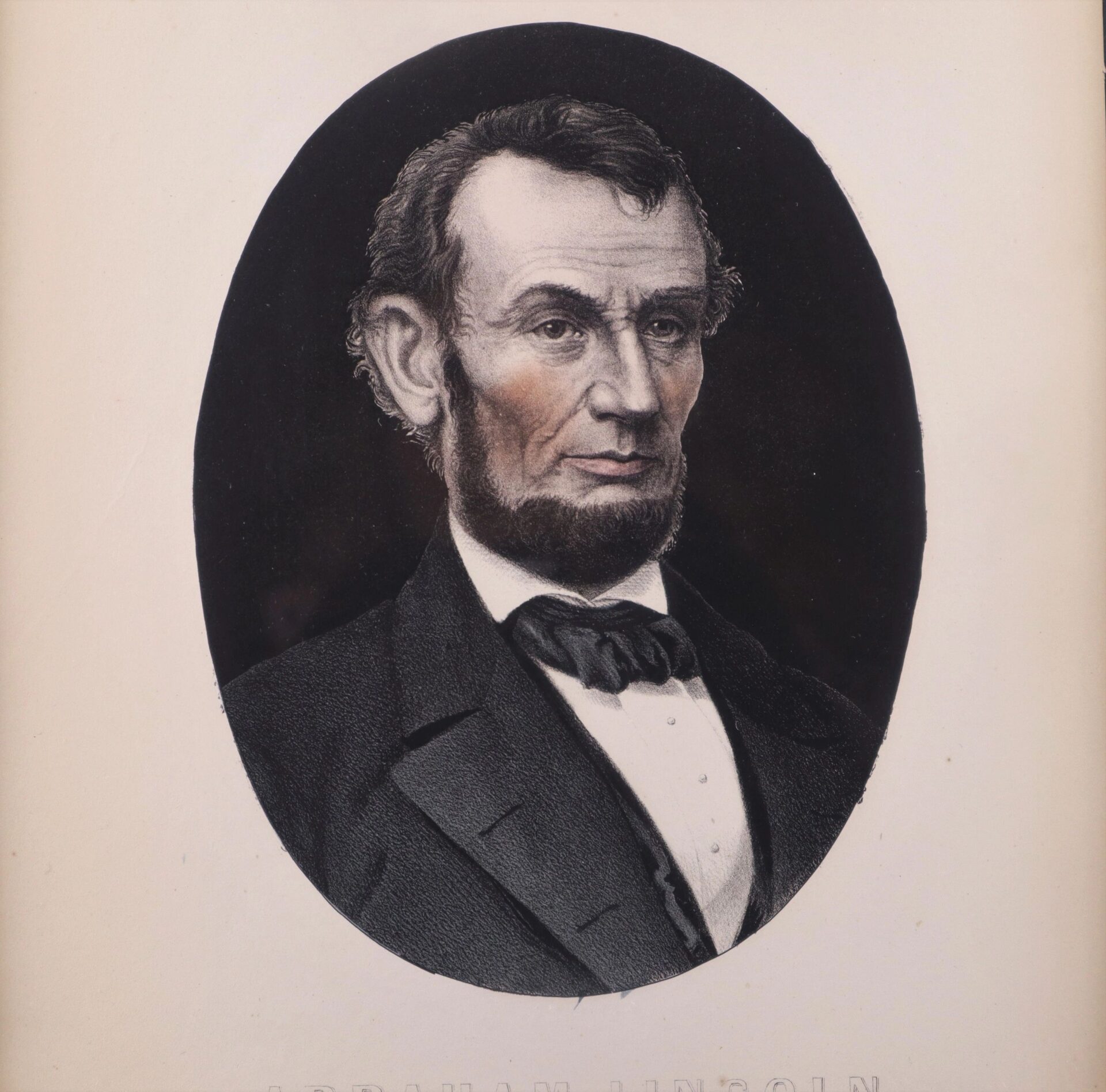An Abraham Lincoln Lithograph featuring an oval portrait of a bearded man in a dark suit, white shirt, and bow tie set against a plain background.