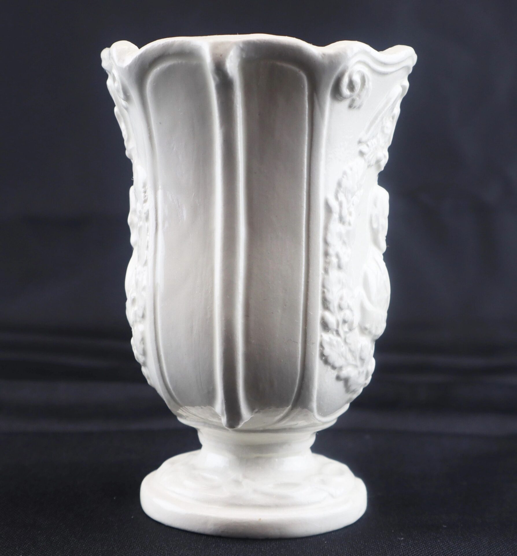 Civil War Vintage Abraham Lincoln Stoneware Vase, featuring vertical ridges and embossed decorative patterns, displayed against a black background.
