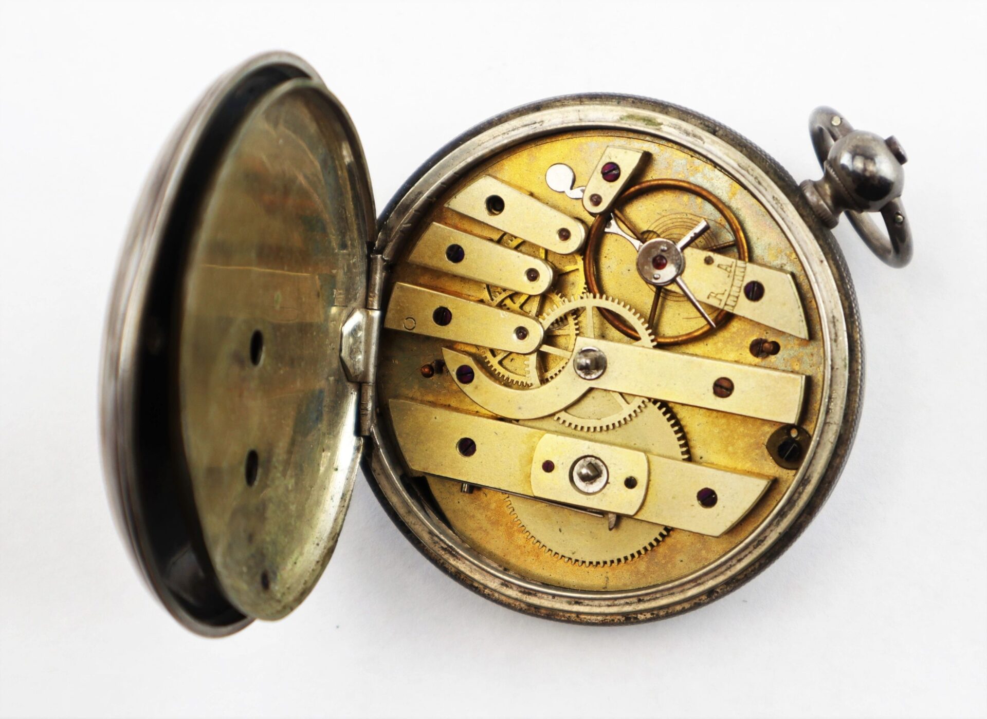 A Silver Pocket Watch with Civil War Engraving, SOLD, shown open to display its internal gears and mechanical components against a white background.