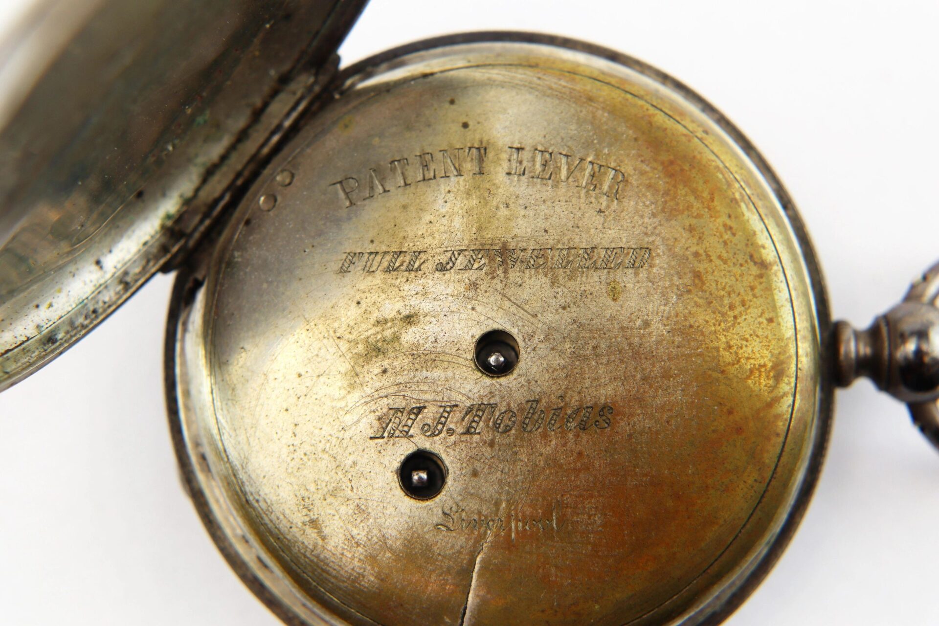 Close-up of the inside of a Silver Pocket Watch with Civil War Engraving (SOLD), showing engraved text and visible tarnish and wear.