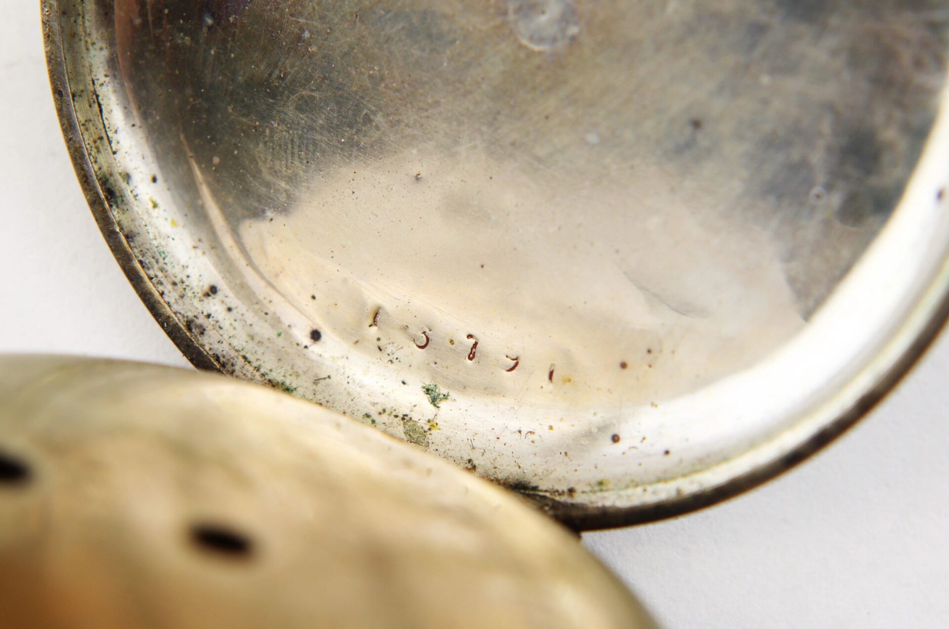 Close-up of the inside of a tarnished Silver Pocket Watch with Civil War Engraving / SOLD, showing the number "1391" engraved on the inner surface.
