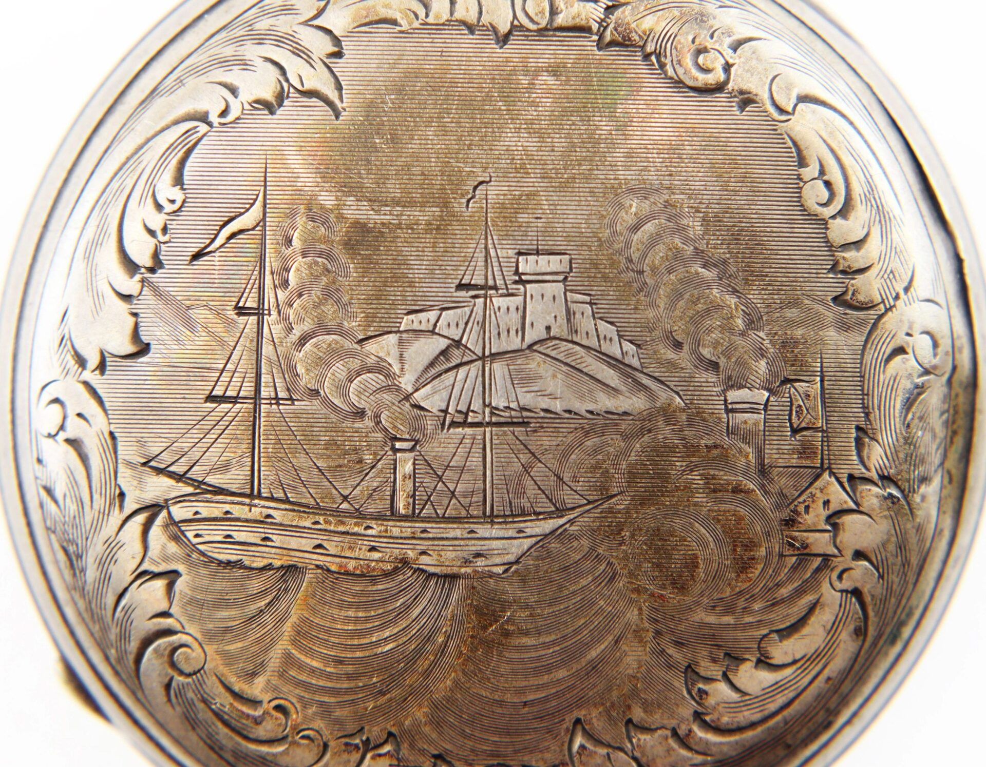 The Silver Pocket Watch with Civil War Engraving features an engraved metal surface showing a steamship at sea, smoke billowing, a fort on a hill in the background, and ornate decorative borders. / SOLD.