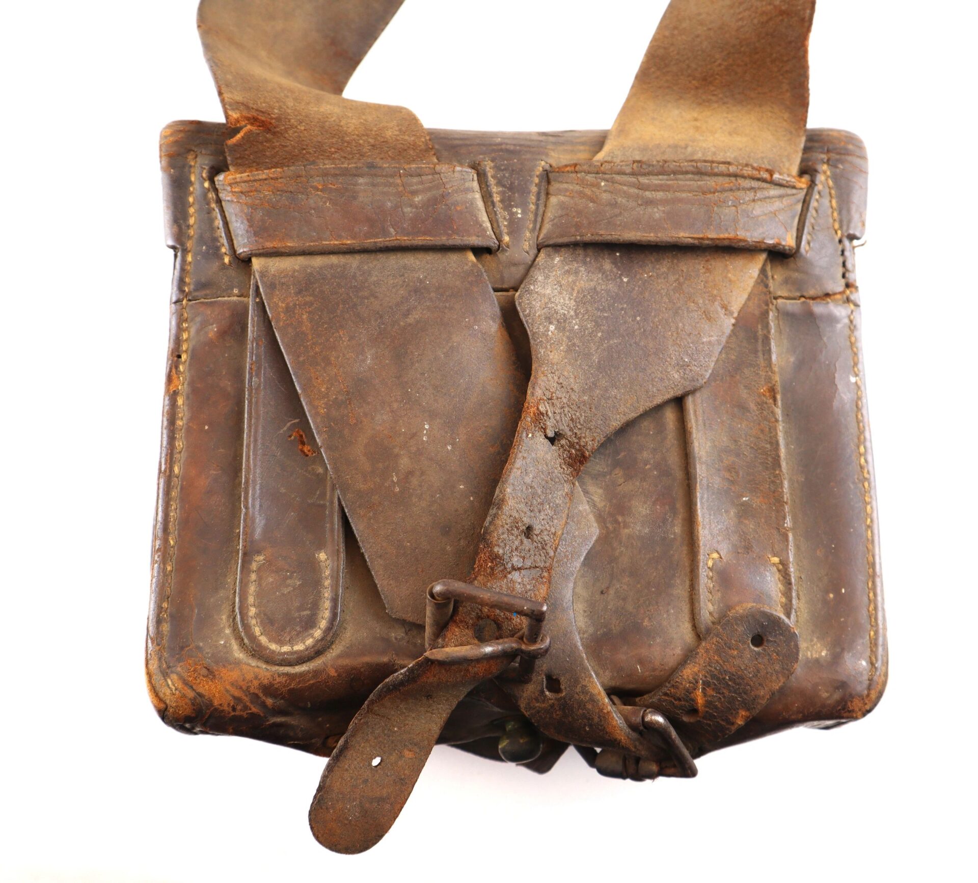 A Complete Cartridge Box with a worn brown leather exterior, wide strap, and visible scuffs and cracks, displayed against a white background.