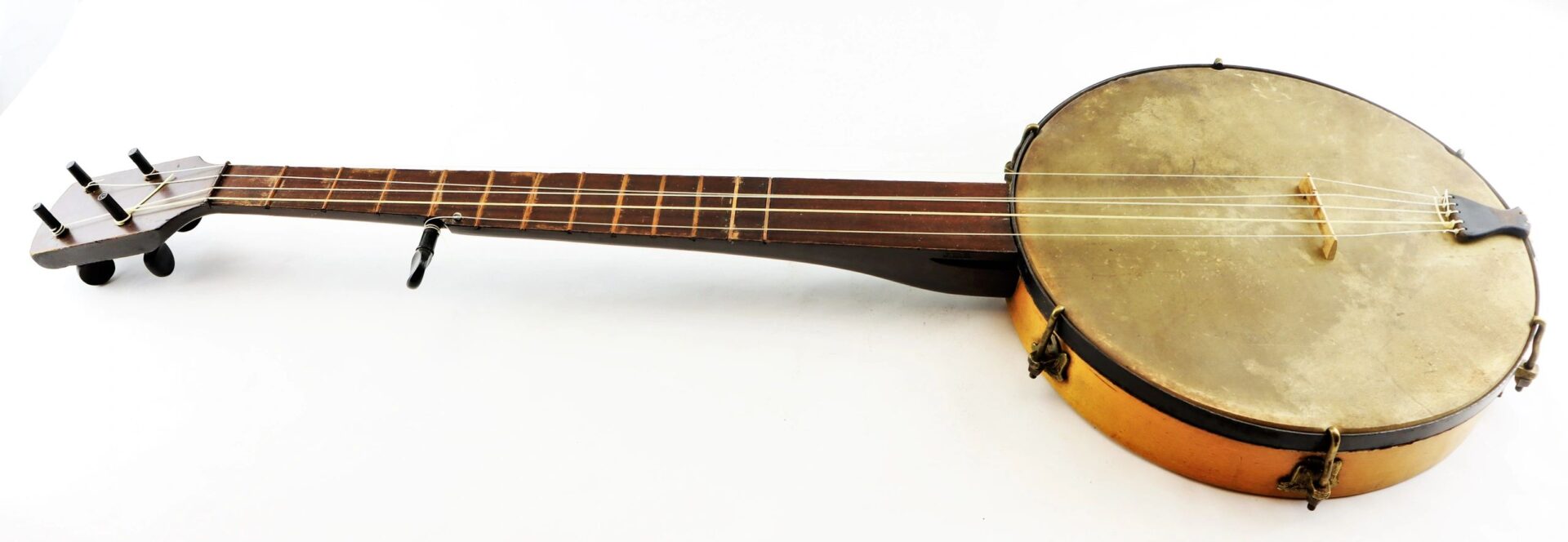 A Civil War Era Banjo with a wooden neck and round drum-like body, photographed on a white background.