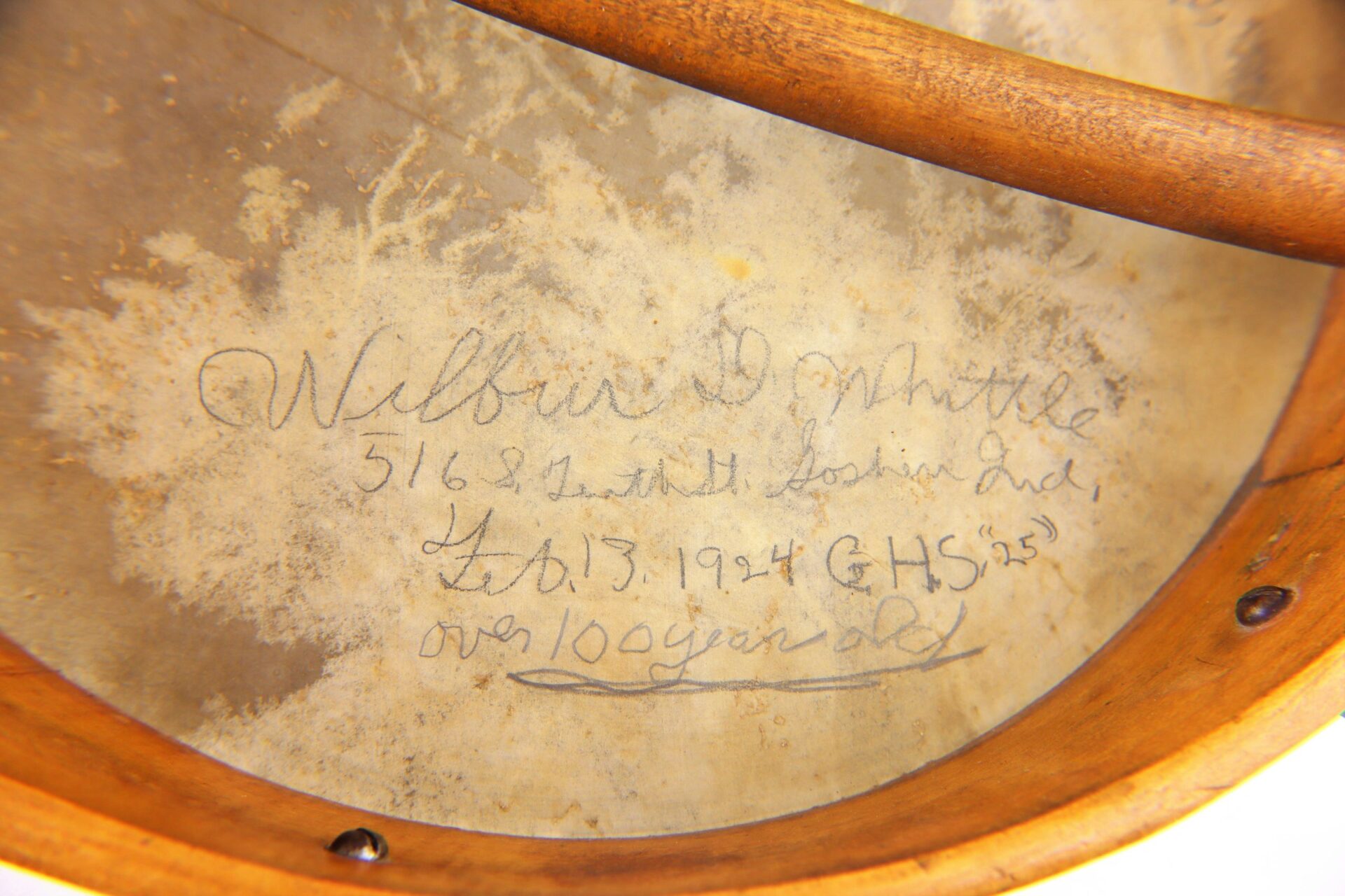 Close-up of a handwritten inscription inside the Civil War Era Banjo, reading: “Wilbur D. Whittle, 5162 South Goshen Ave, Feb. 13, 1924 GHS ’25, over 100 years old.” Banjo is SOLD.