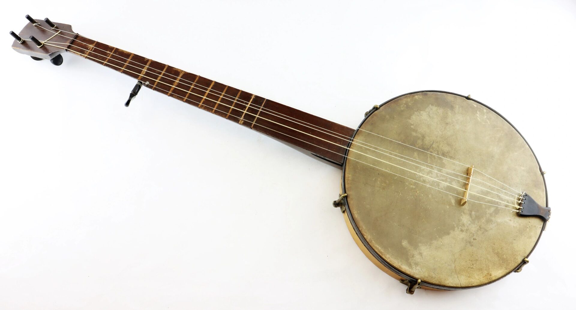 A Civil War Era Banjo with a wooden neck and circular drum body, photographed on a white background.