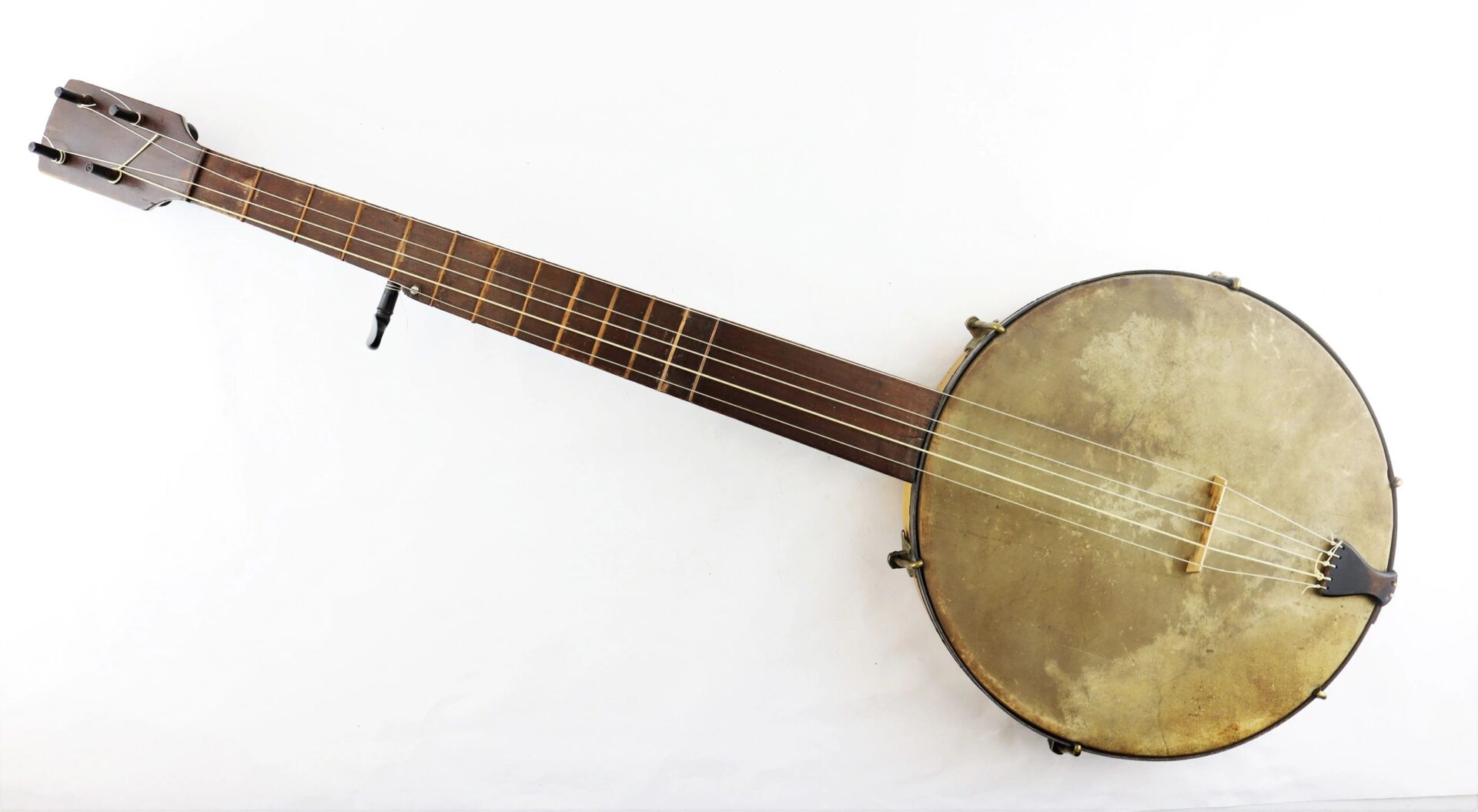 A full view of a Civil War Era Banjo / SOLD, featuring a five-string design with a wooden neck and circular drum-like body, photographed on a white background.