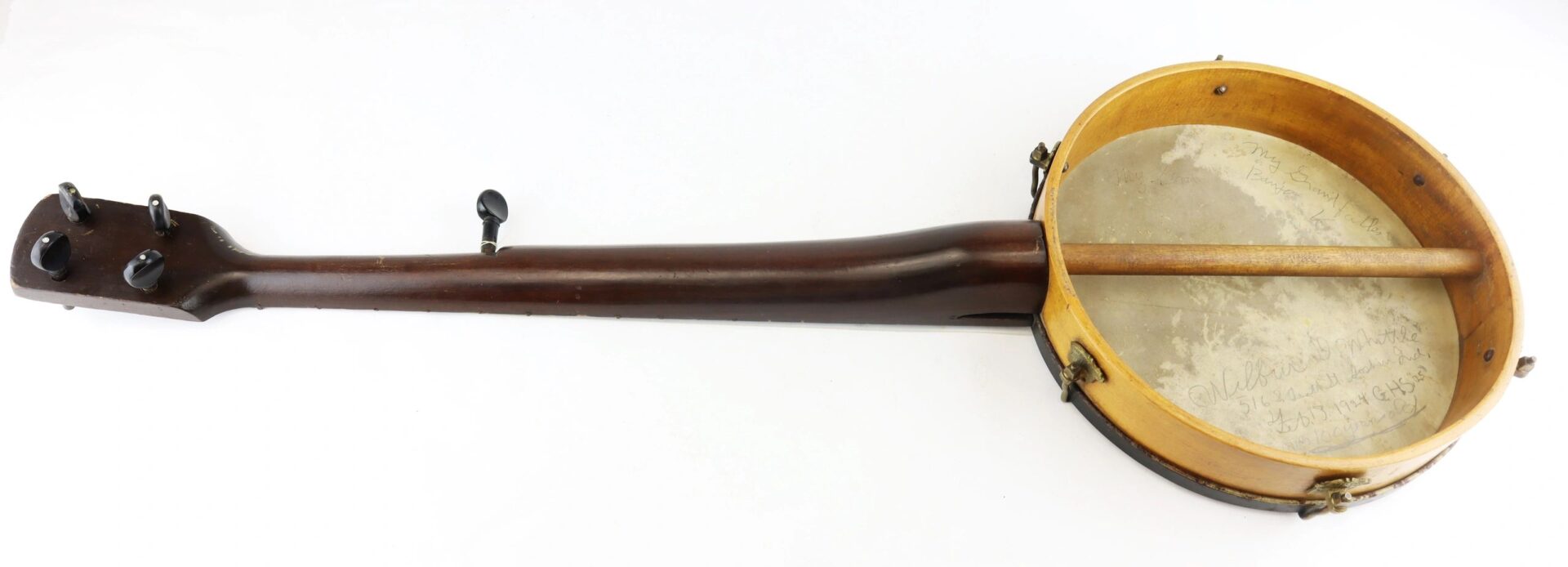 A Civil War Era Banjo with a wooden neck and circular drum-like body, viewed from above against a white background.