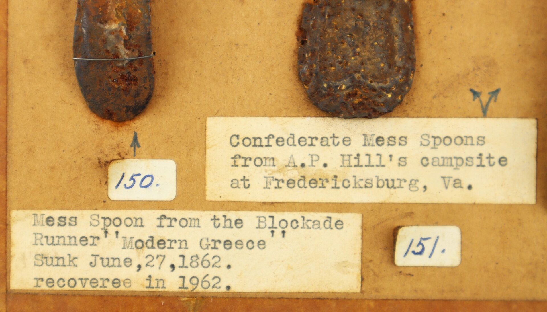 A Collection of Relic Civil War Utensils includes two labeled rusted spoons displayed on a board, with captions noting their origins: A.P. Hill’s campsite and the ship "Modern Greece," recovered in 1962. / Sold.