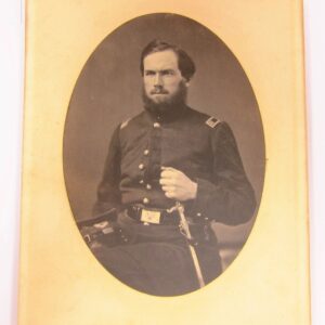A bearded man in military uniform poses for a portrait, hand on belt, in this vintage Surgeon Albumen Photo.